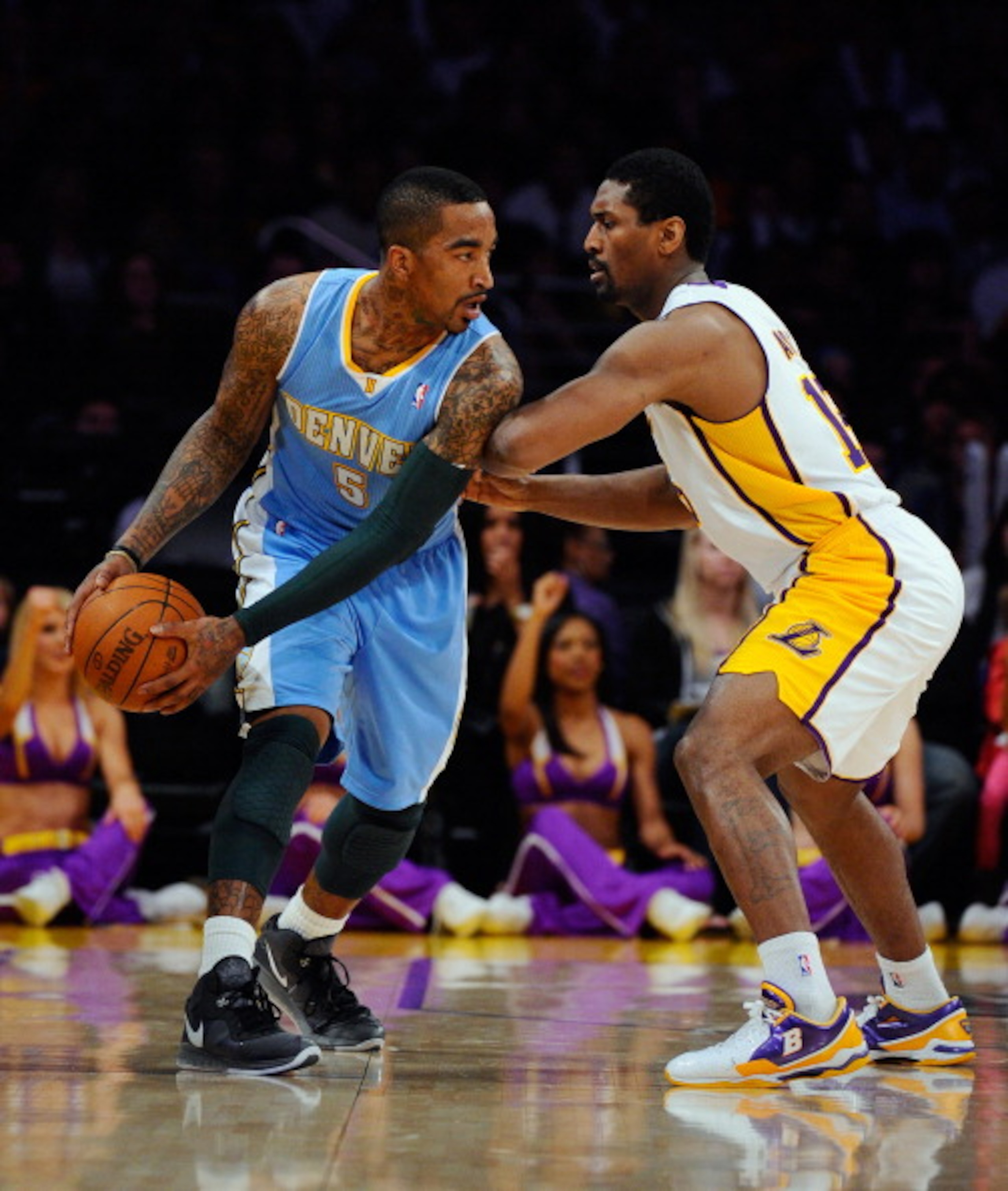 LOS ANGELES, CA - APRIL 03:  Ron Artest #15 of the Los Angeles Lakers defends against JR Smith #5 of the Denver Nuggets at Staples Center on April 3, 2011 in Los Angeles, California. NOTE TO USER: User expressly acknowledges and agrees that, by downloadin
