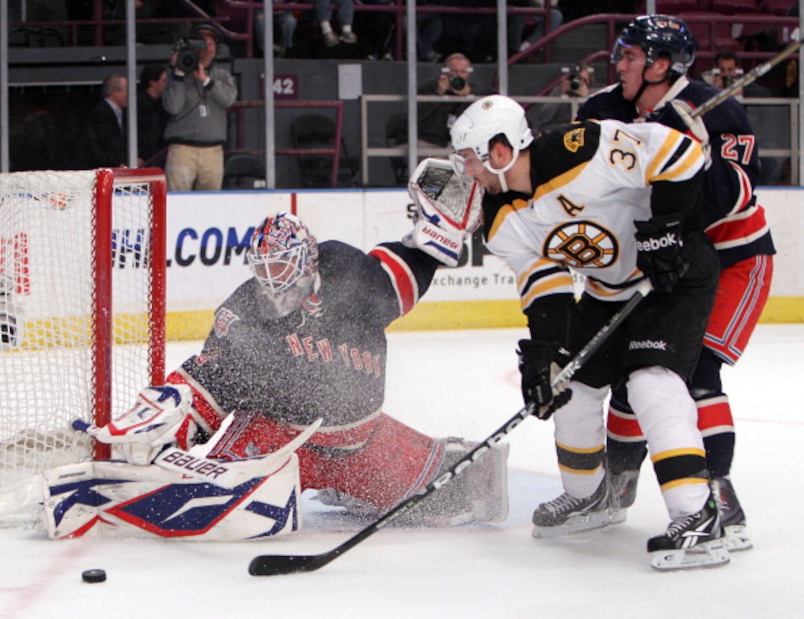 NEW YORK, NY - APRIL 04: Patrice Bergeron #37 of the Boston Bruins is stopped by Henrik Lundqvist #30 of the New York Rangers during the first period at Madison Square Garden on April 4, 2011 in New York City.  (Photo by Bruce Bennett/Getty Images)