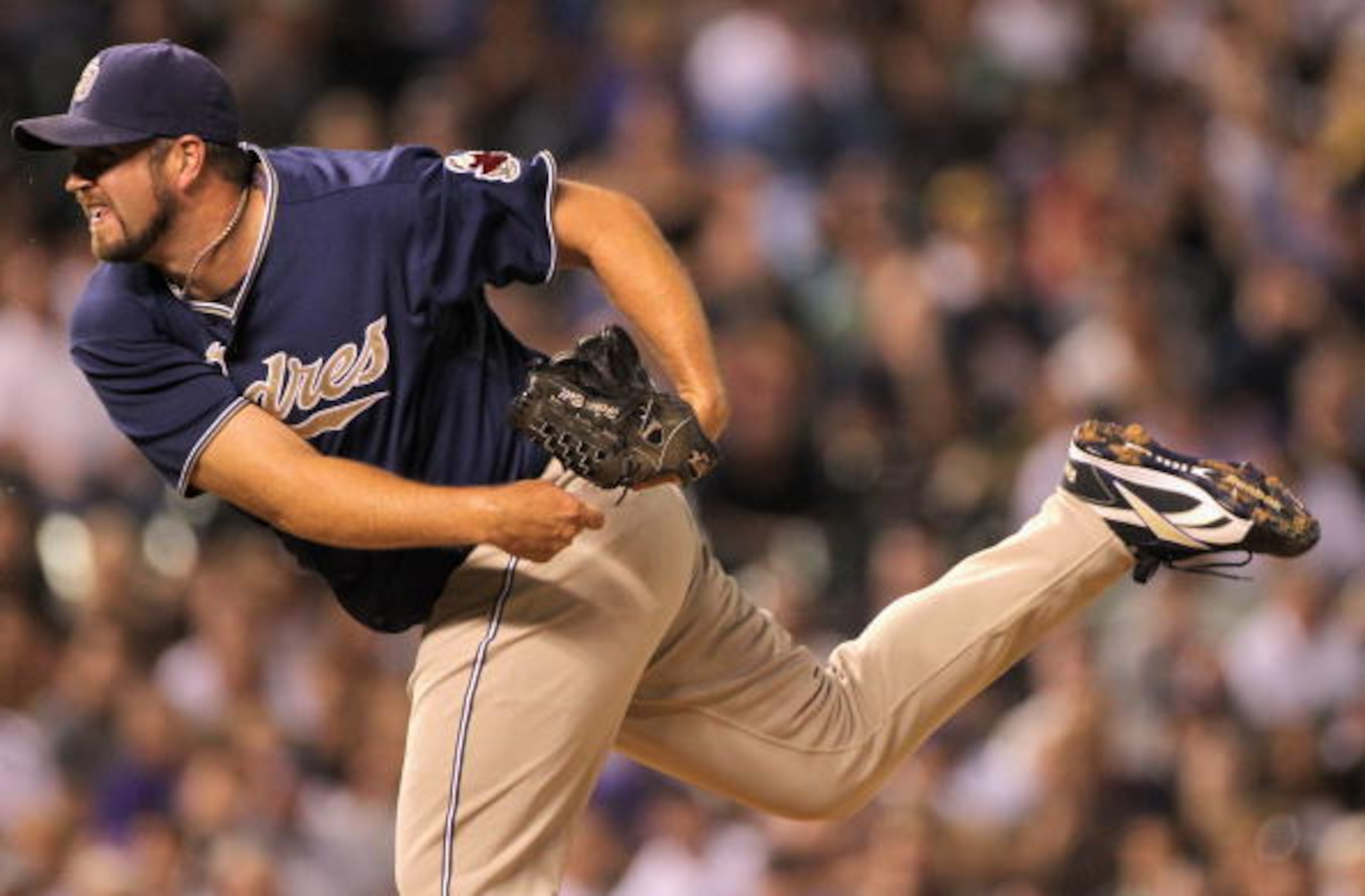 DENVER - SEPTEMBER 13:  Relief pitcher Heath Bell #21 of the San Diego Padres delivers against the Colorado Rockies at Coors Field on September 13, 2010 in Denver, Colorado. Bell recorded a save as the Padres defeated the Rockies 6-4.  (Photo by Doug Pens