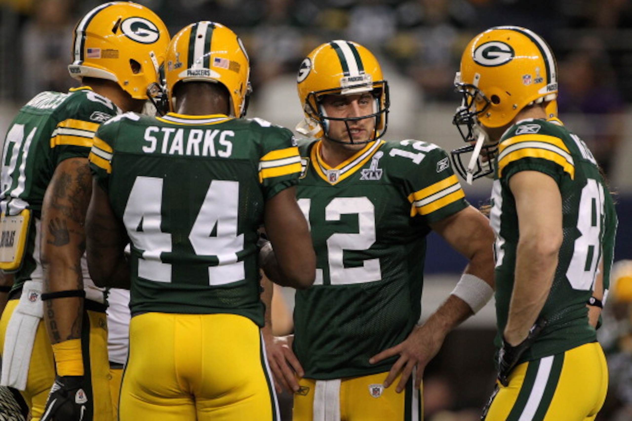 ARLINGTON, TX - FEBRUARY 06:  Aaron Rodgers #12 of the Green Bay Packers talks to teammates prior to their game against the Pittsburgh Steelers during Super Bowl XLV at Cowboys Stadium on February 6, 2011 in Arlington, Texas.  (Photo by Doug Pensinger/Get
