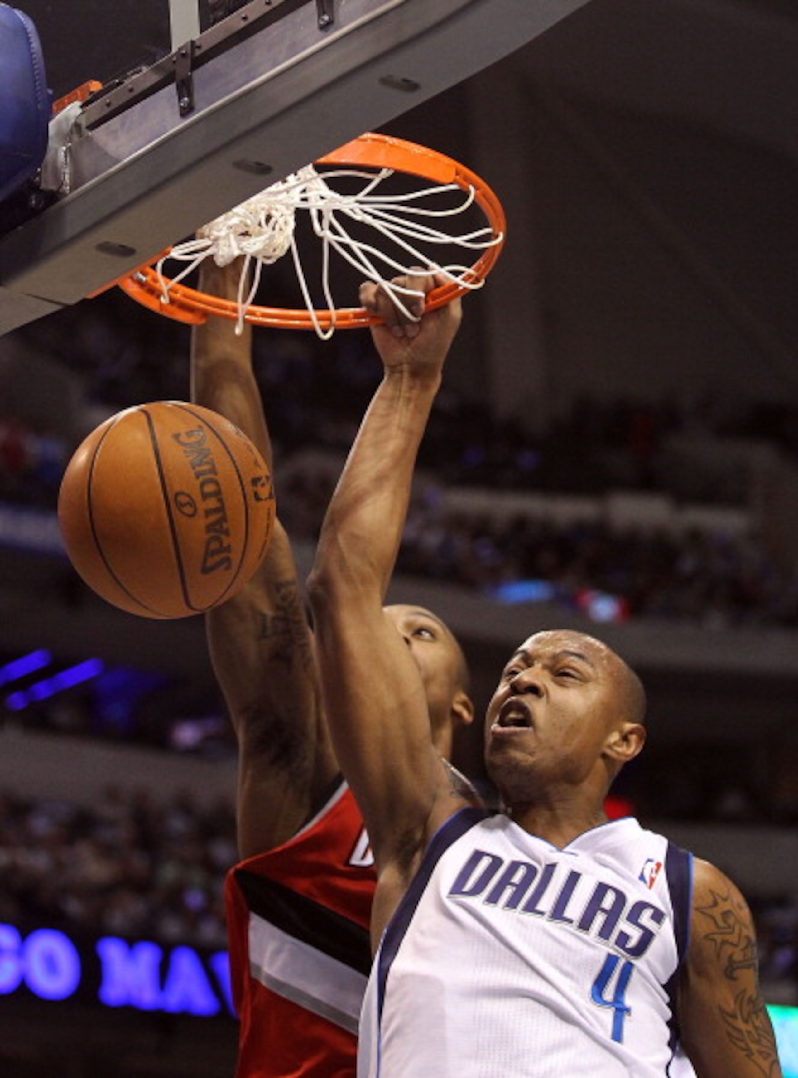 DALLAS, TX - DECEMBER 15:  Forward Caron Butler #4 of the Dallas Mavericks makes a slam dunk against Dante Cunningham #33 of the Portland Trail Blazers at American Airlines Center on December 15, 2010 in Dallas, Texas.  NOTE TO USER: User expressly acknow
