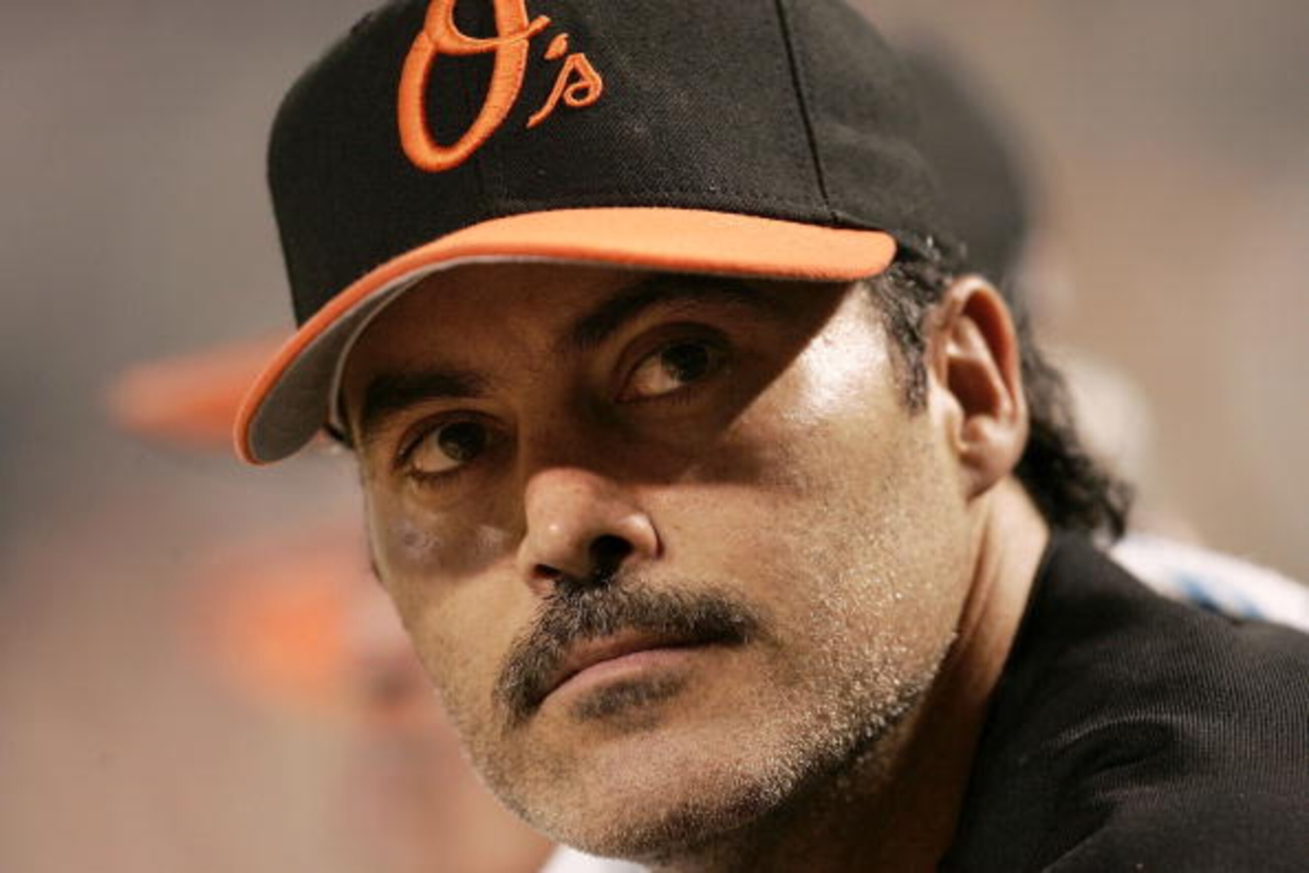 BALTIMORE - AUGUST 12: Rafael Palmeiro #25 of the Baltimore Orioles watches from the dugout as his team plays against the Toronto Blue Jays August 12, 2005 at Oriole Park at Camden Yards in Baltimore, Maryland. Palmeiro was named in the Mitchell Report t BALTIMORE - AUGUST 12: Rafael Palmeiro #25 of the Baltimore Orioles watches from the dugout as his team plays against the Toronto Blue Jays August 12, 2005 at Oriole Park at Camden Yards in Baltimore, Maryland. Palmeiro was named in the Mitchell Report t