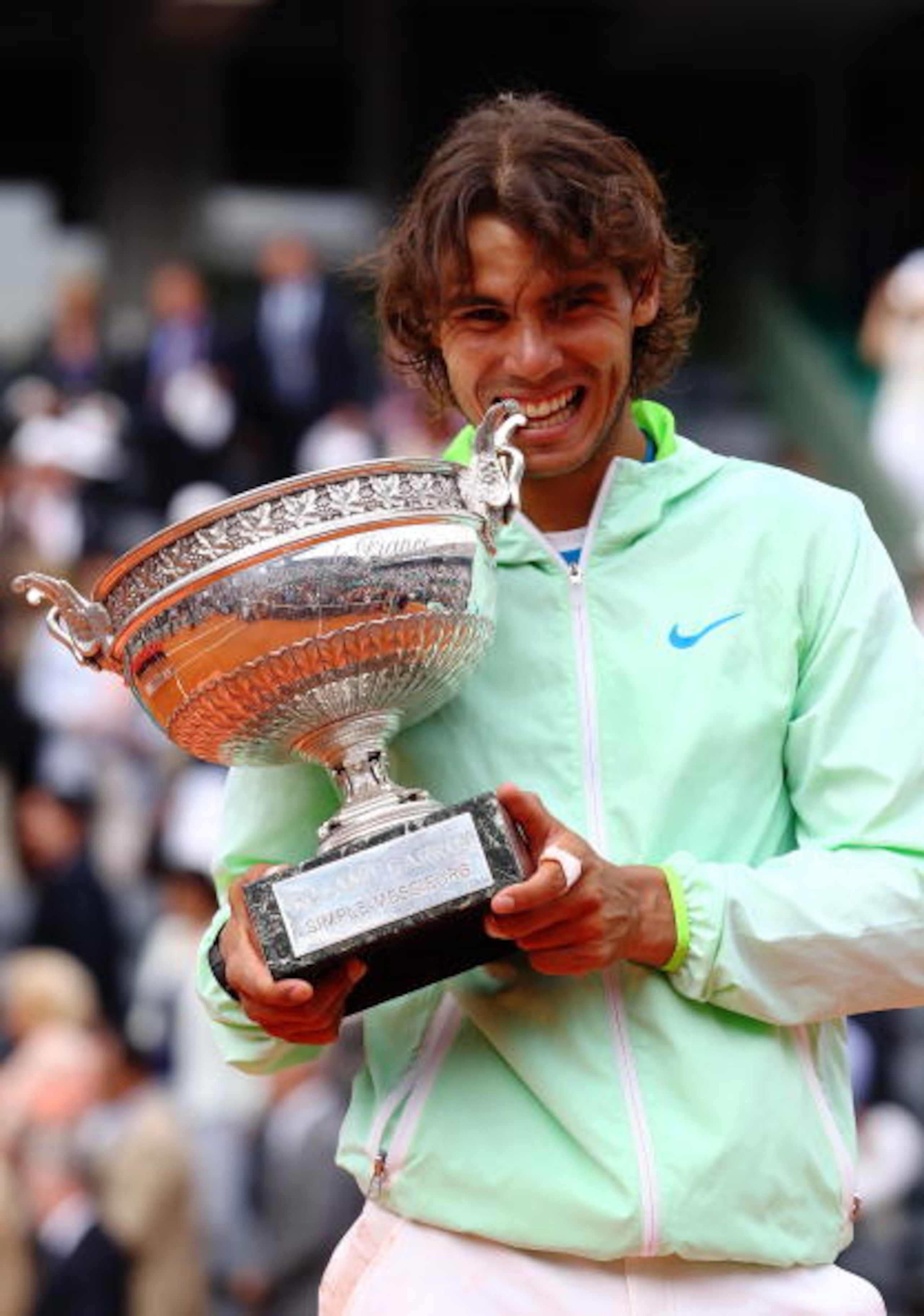 PARIS - JUNE 06:  Rafael Nadal of Spain celebrates with the trophy after winning the men's singles final match between Rafael Nadal of Spain and Robin Soderling of Sweden on day fifteen of the French Open at Roland Garros on June 6, 2010 in Paris, France.