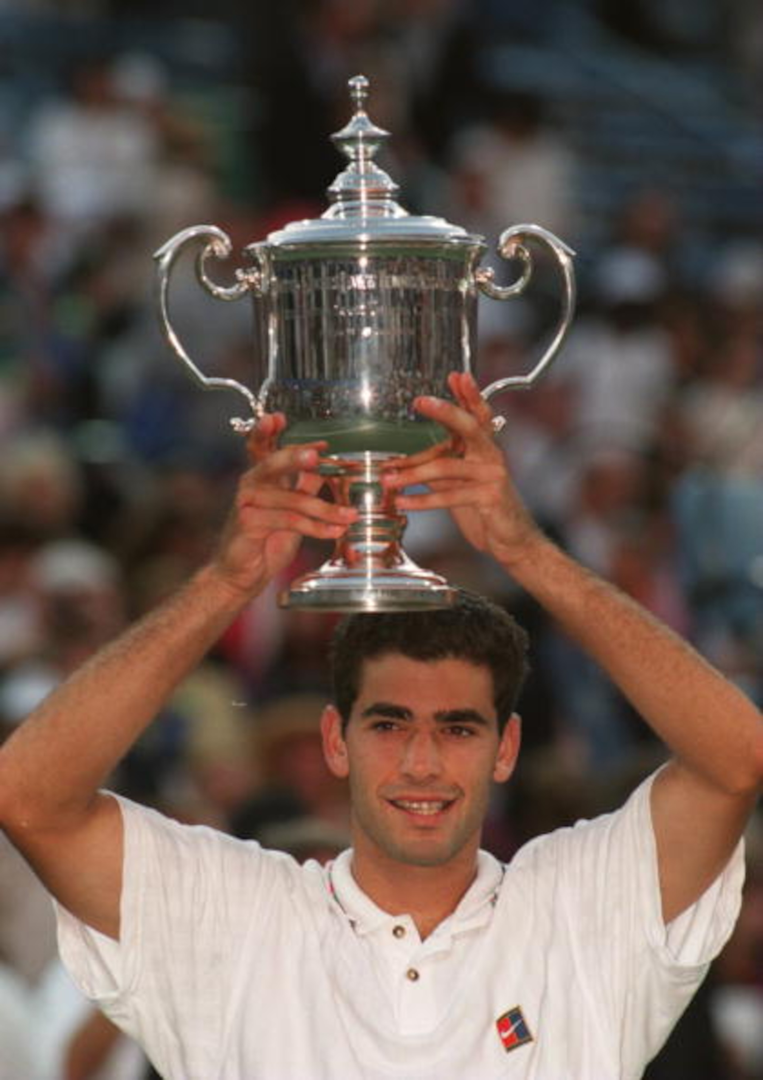 10 Sep 1995: PETE SAMPRAS OF THE USA HOLDS UP THE TROPHY AS HE REJOICES AT HIS VICTORY AGAINST ANDRE AGASSI IN THE FINAL OF THE MENS SINGLES AT THE US OPEN IN FLUSHING MEADOW, NEW YORK, UNITED STATES.