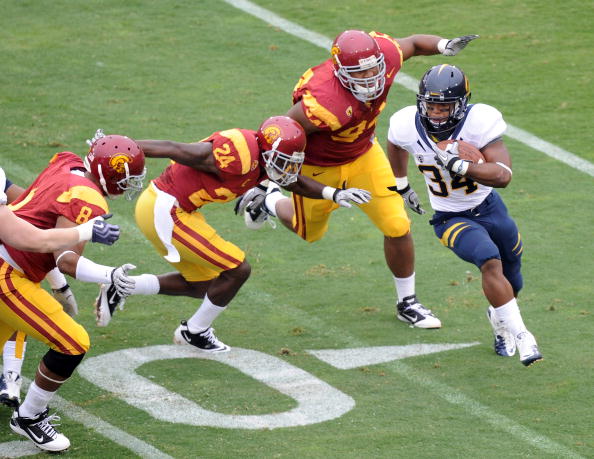 LOS ANGELES, CA - OCTOBER 16:  Shane Vereen #34 of the California Golden Bears is chased by Armond Armstead #94, Shareece Wright #24 and Nick Perry #8 of the USC Trojans during the first quarter at Los Angeles Memorial Coliseum on October 16, 2010 in Los
