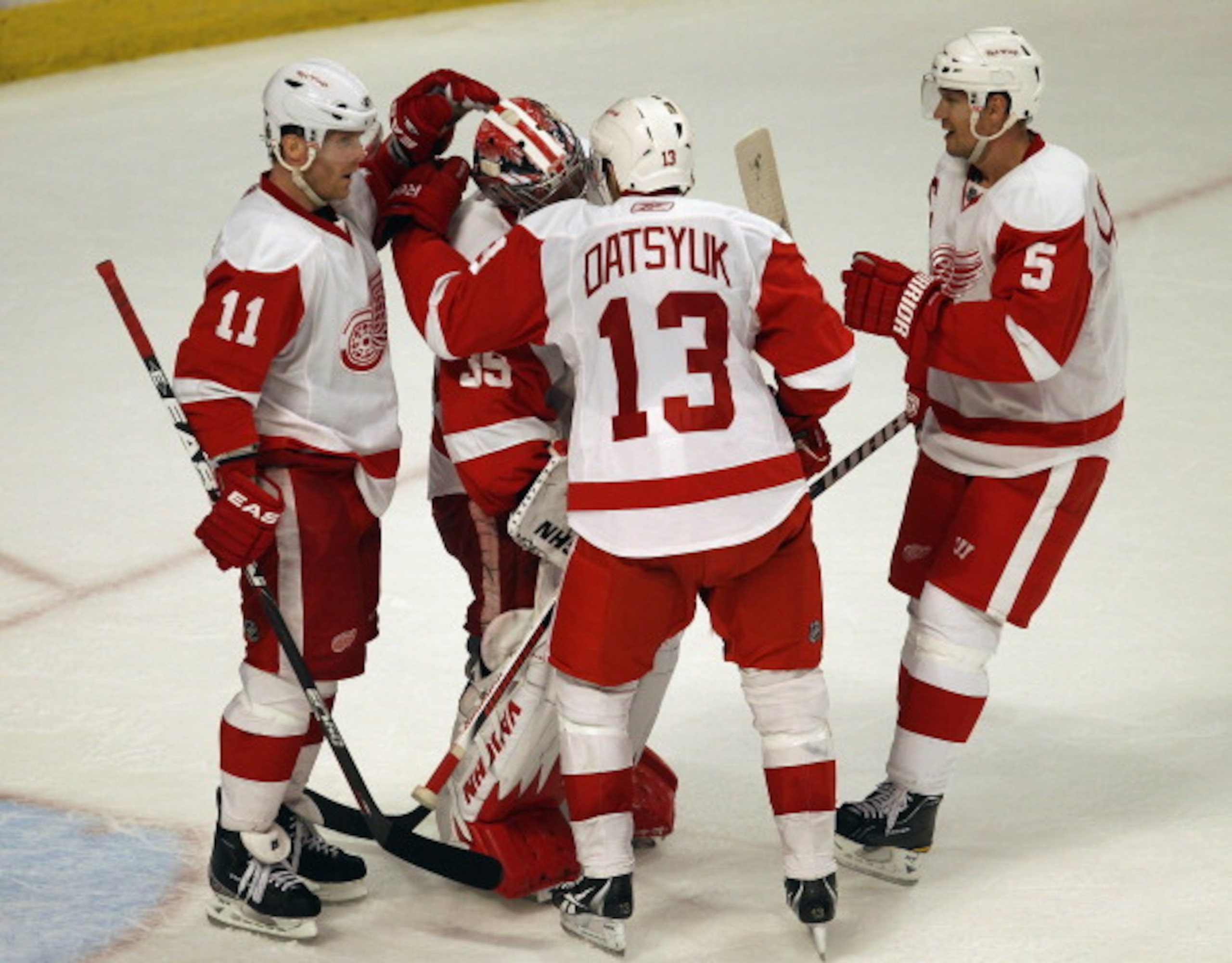 CHICAGO, IL - APRIL 10: (L-R) Danny Cleary #11, Jimmy Howard #35, Pavel Datsyuk #13 and Nicklas Lidstrom #5 of the Detroit Red Wings celebrate a win over the Chicago Blackhawks at the United Center on April 10, 2011 in Chicago, Illinois. The Red Wings def CHICAGO, IL - APRIL 10: (L-R) Danny Cleary #11, Jimmy Howard #35, Pavel Datsyuk #13 and Nicklas Lidstrom #5 of the Detroit Red Wings celebrate a win over the Chicago Blackhawks at the United Center on April 10, 2011 in Chicago, Illinois. The Red Wings def