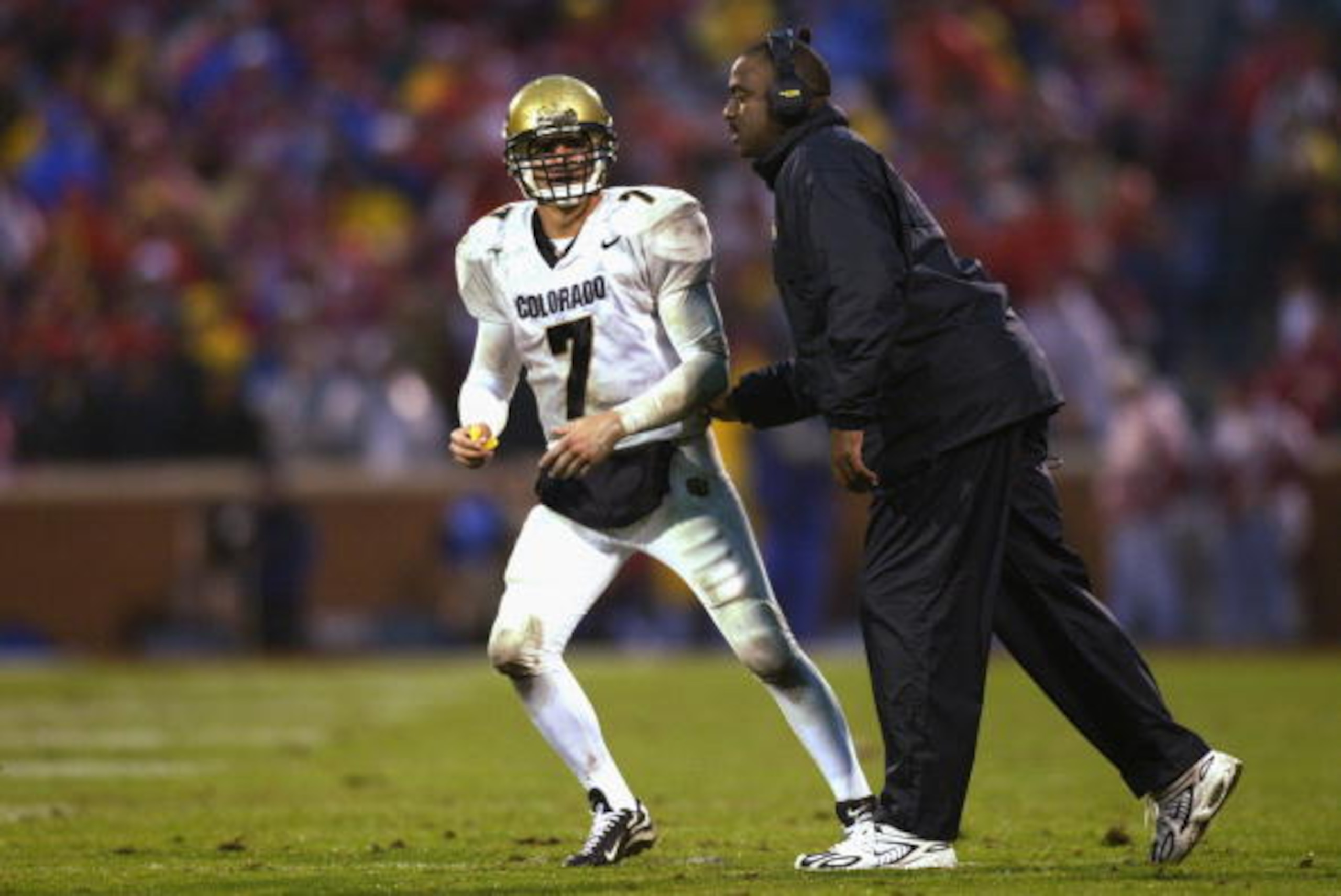 NORMAN, OK - NOVEMBER 2:  Quarterback Robert Hodge #7 of the Colorado Buffaloes gets instruction by Wide Receivers coach Jon Embree during the game against the Oklahoma Sooners at Memorial Stadium on November 2, 2002 in Norman, Oklahoma.  The Sooners won