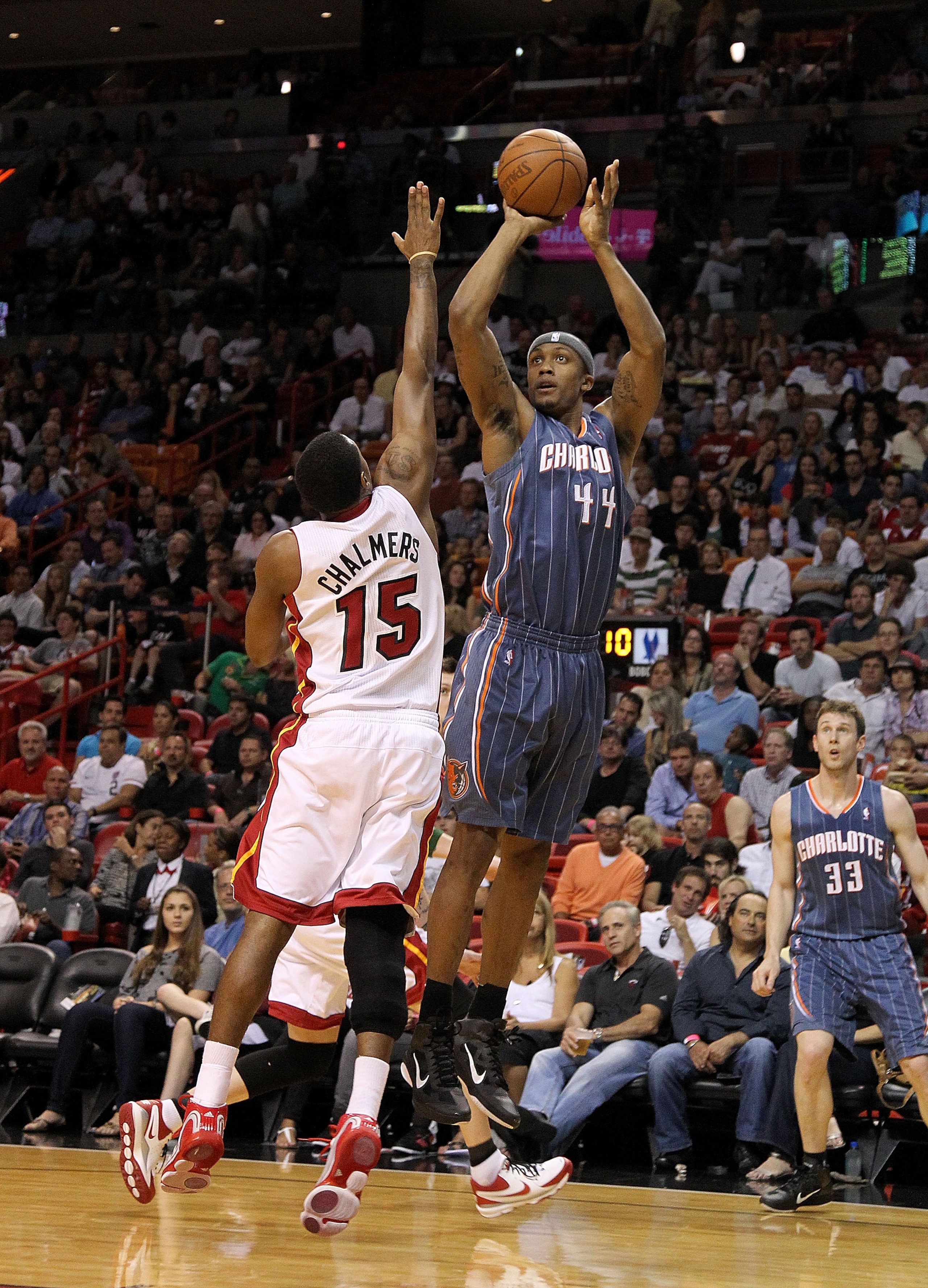 MIAMI, FL - APRIL 08:  Dante Cunningham #44 of the Charlotte Bobcats shoots over Mario Chalmers #15 of the Miami Heat during a game at American Airlines Arena on April 8, 2011 in Miami, Florida. NOTE TO USER: User expressly acknowledges and agrees that, b