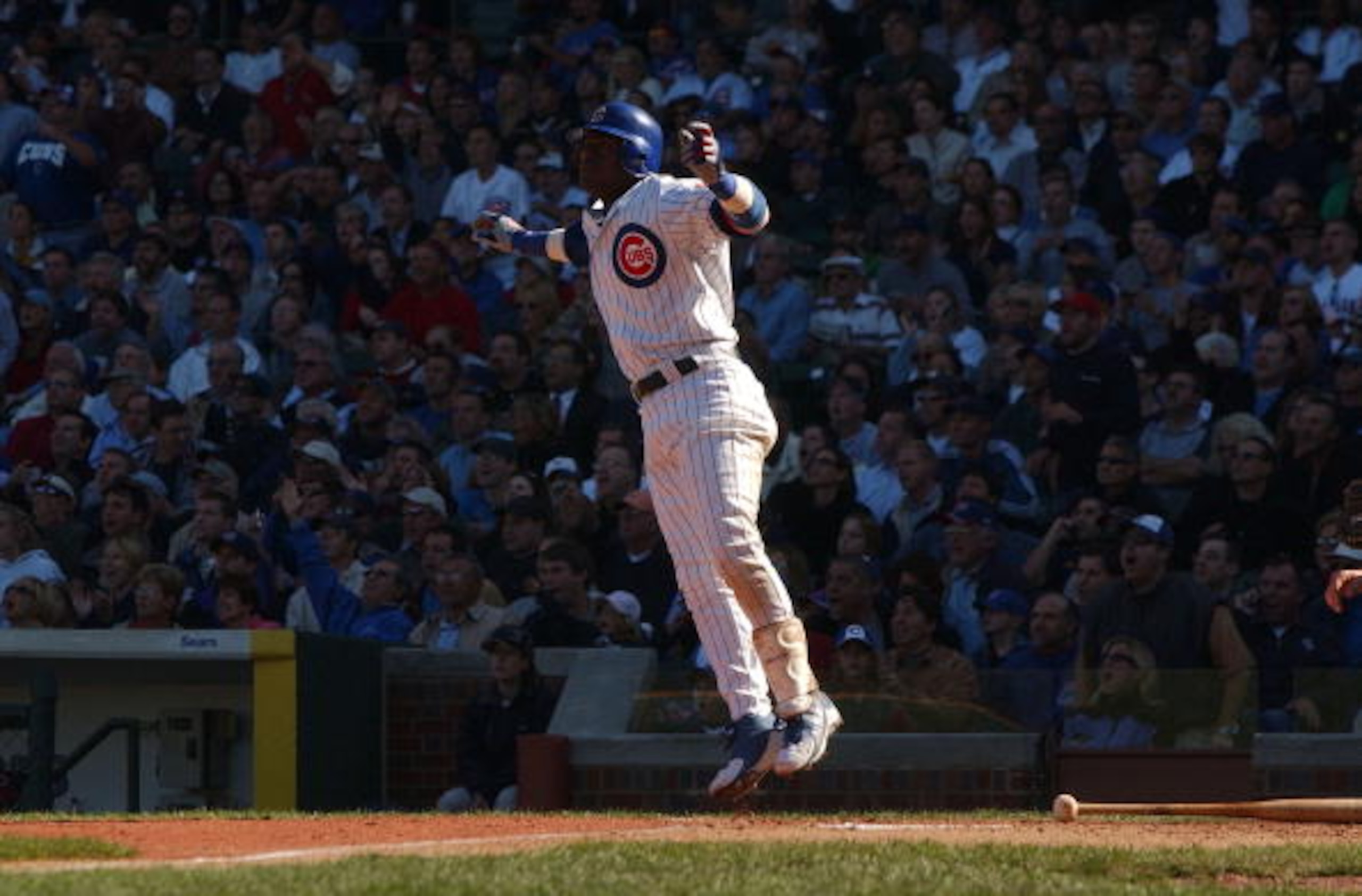 CHICAGO - SEPTEMBER 30: Sammy Sosa #21 of the Chicago Cubs hops after hitting a solo home run in the sixth inning against the Cincinnati Reds during a game on September 30, 2004 at Wrigley Field in Chicago, Illinois. (Photo by Jonathan Daniel/Getty Image CHICAGO - SEPTEMBER 30: Sammy Sosa #21 of the Chicago Cubs hops after hitting a solo home run in the sixth inning against the Cincinnati Reds during a game on September 30, 2004 at Wrigley Field in Chicago, Illinois. (Photo by Jonathan Daniel/Getty Image