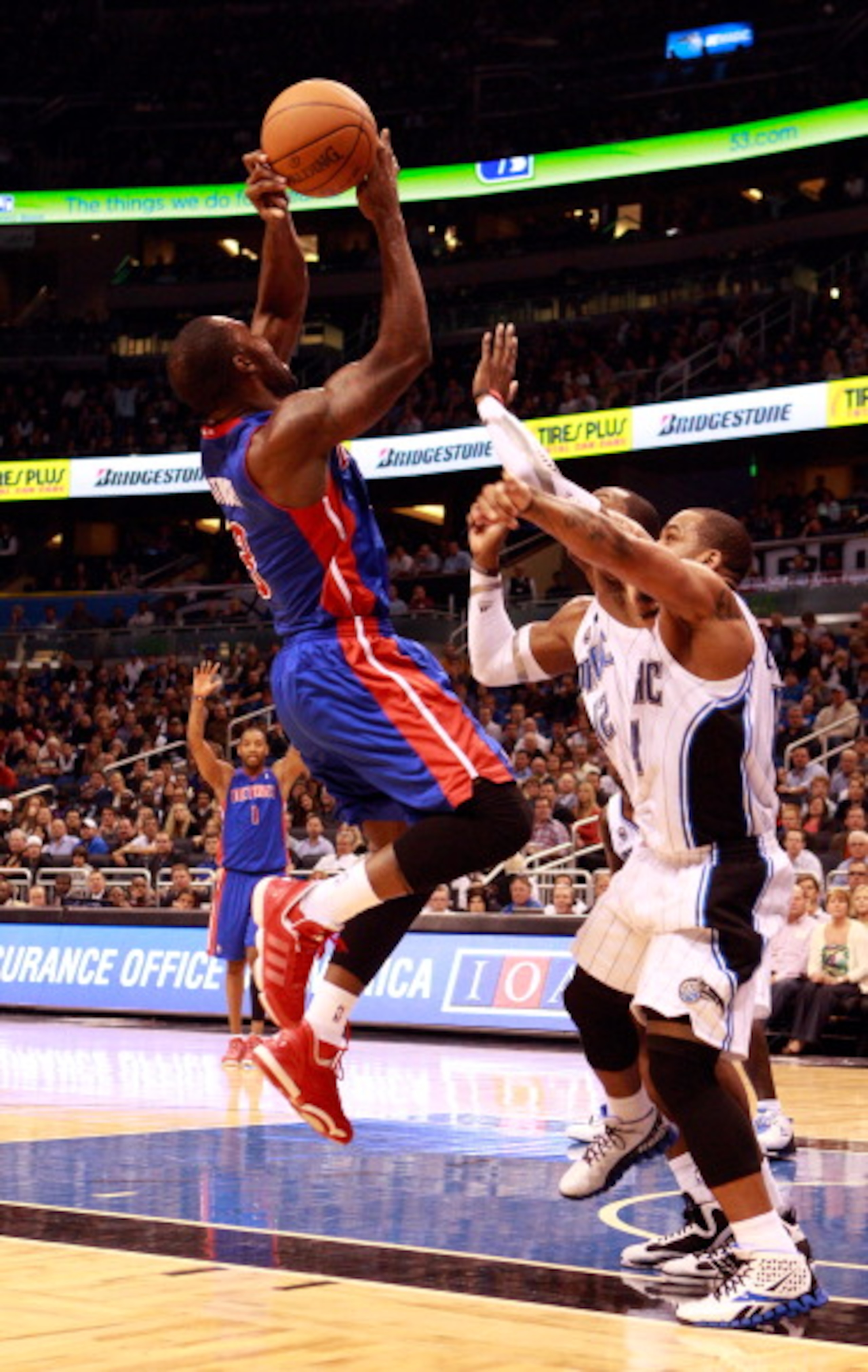 ORLANDO, FL - JANUARY 24:  Rodney Stuckey #3 of the Detroit Pistons attempts a shot against Dwight Howard #12 and Jameer Nelson #14 of the Orlando Magic during the game at Amway Arena on January 24, 2011 in Orlando, Florida.  NOTE TO USER: User expressly
