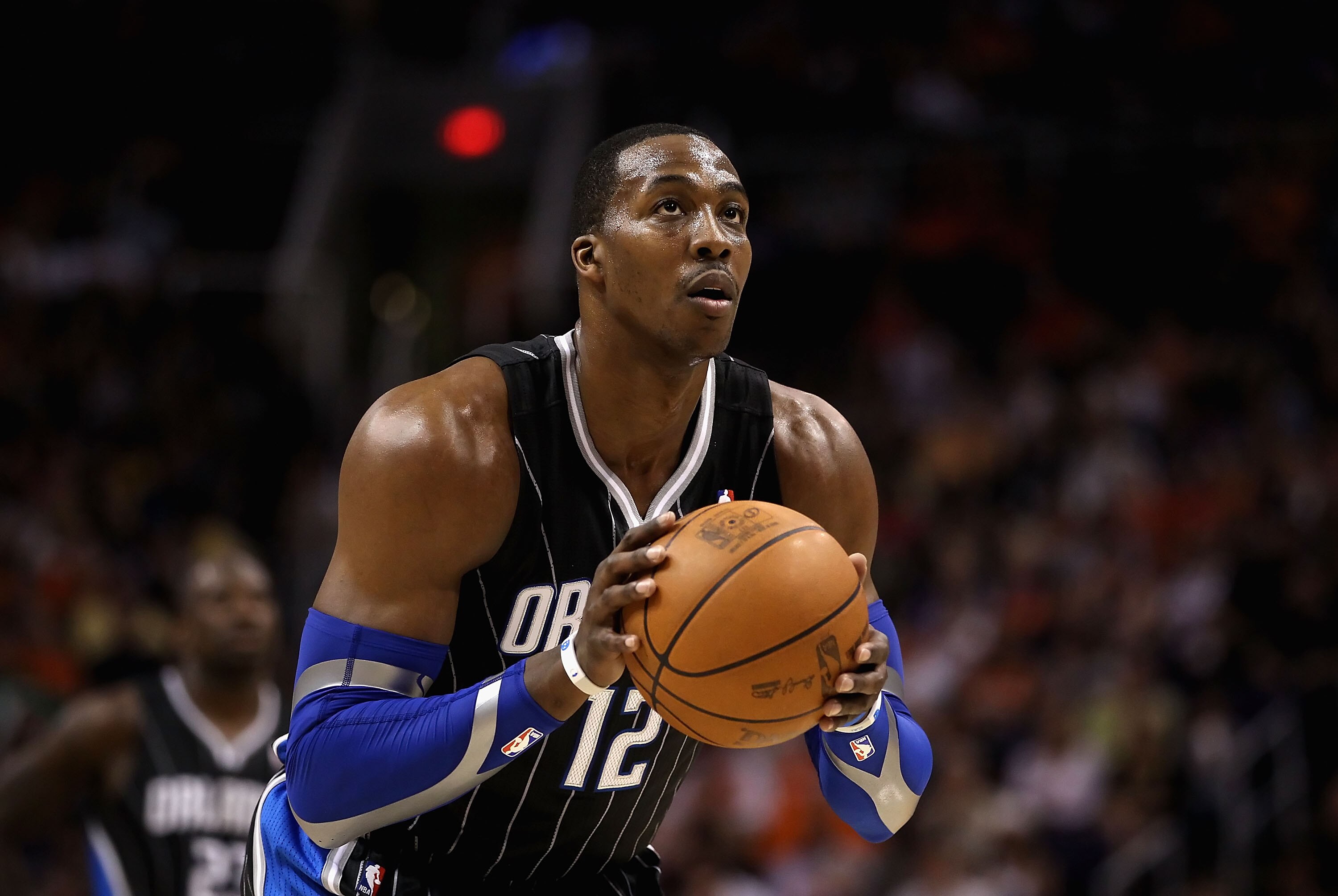 PHOENIX, AZ - MARCH 13:  Dwight Howard #12 of the Orlando Magic shoots a free throw shot during the NBA game against the Phoenix Suns at US Airways Center on March 13, 2011 in Phoenix, Arizona. The Magic defeated the Suns 111-88. NOTE TO USER: User expres