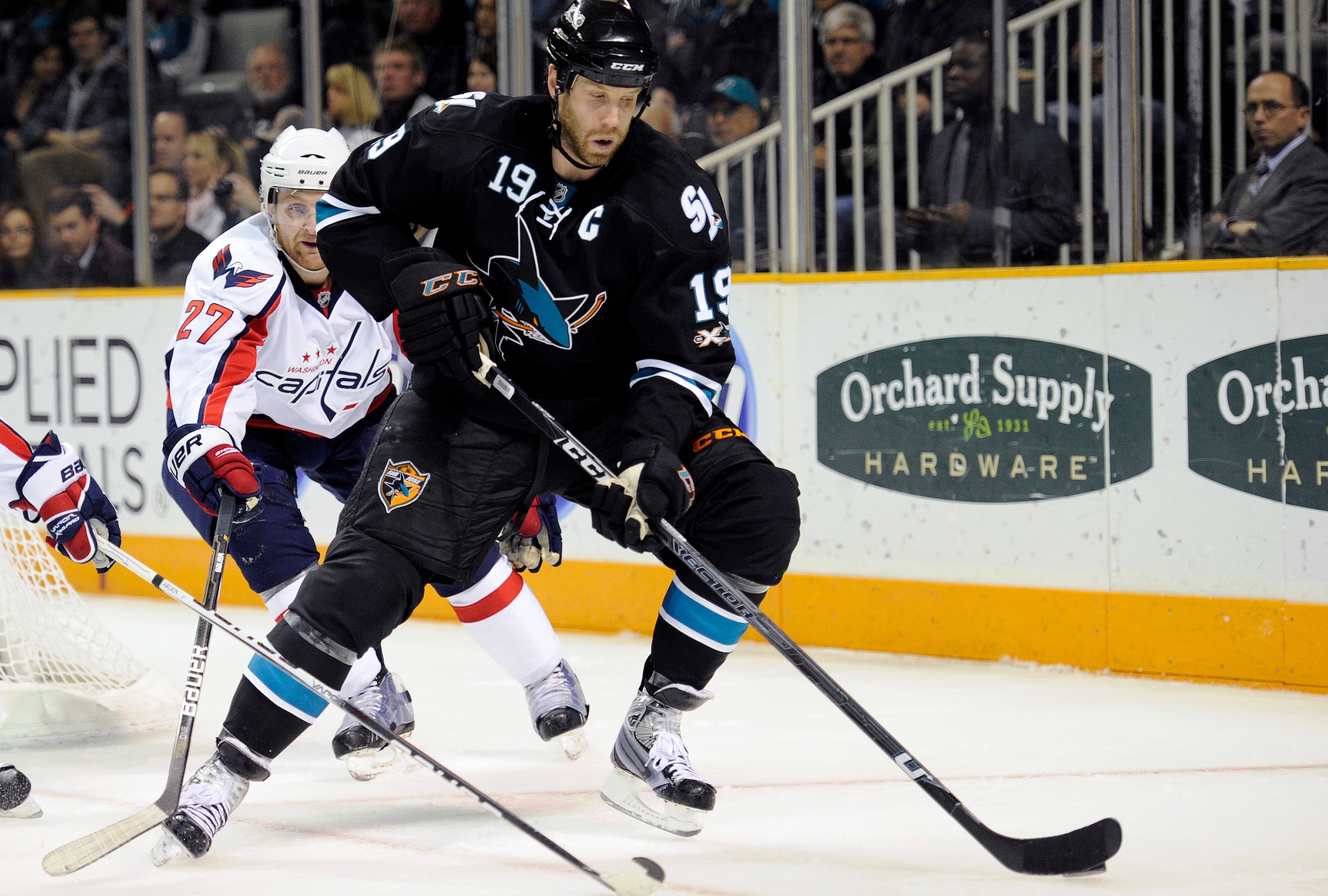 SAN JOSE, CA - FEBRUARY 17: Joe Thornton #19 of the San Jose Sharks controls the puck in front of Karl Alzner #27 of the Washington Capitals in the second period during an NHL hockey game at the HP Pavilion on February 17, 2011 in San Jose, California. (P