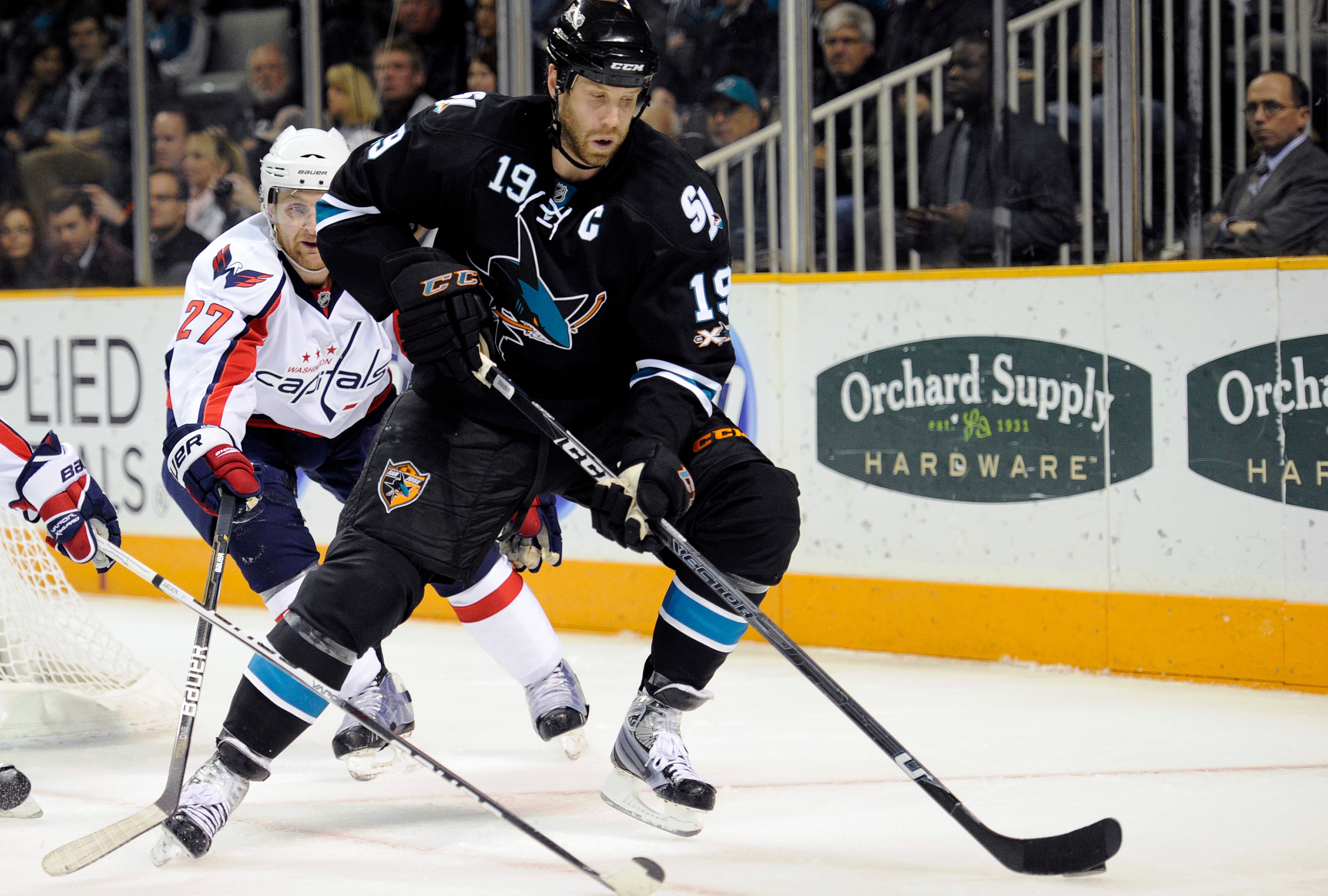 SAN JOSE, CA - FEBRUARY 17: Joe Thornton #19 of the San Jose Sharks controls the puck in front of Karl Alzner #27 of the Washington Capitals in the second period during an NHL hockey game at the HP Pavilion on February 17, 2011 in San Jose, California. (P