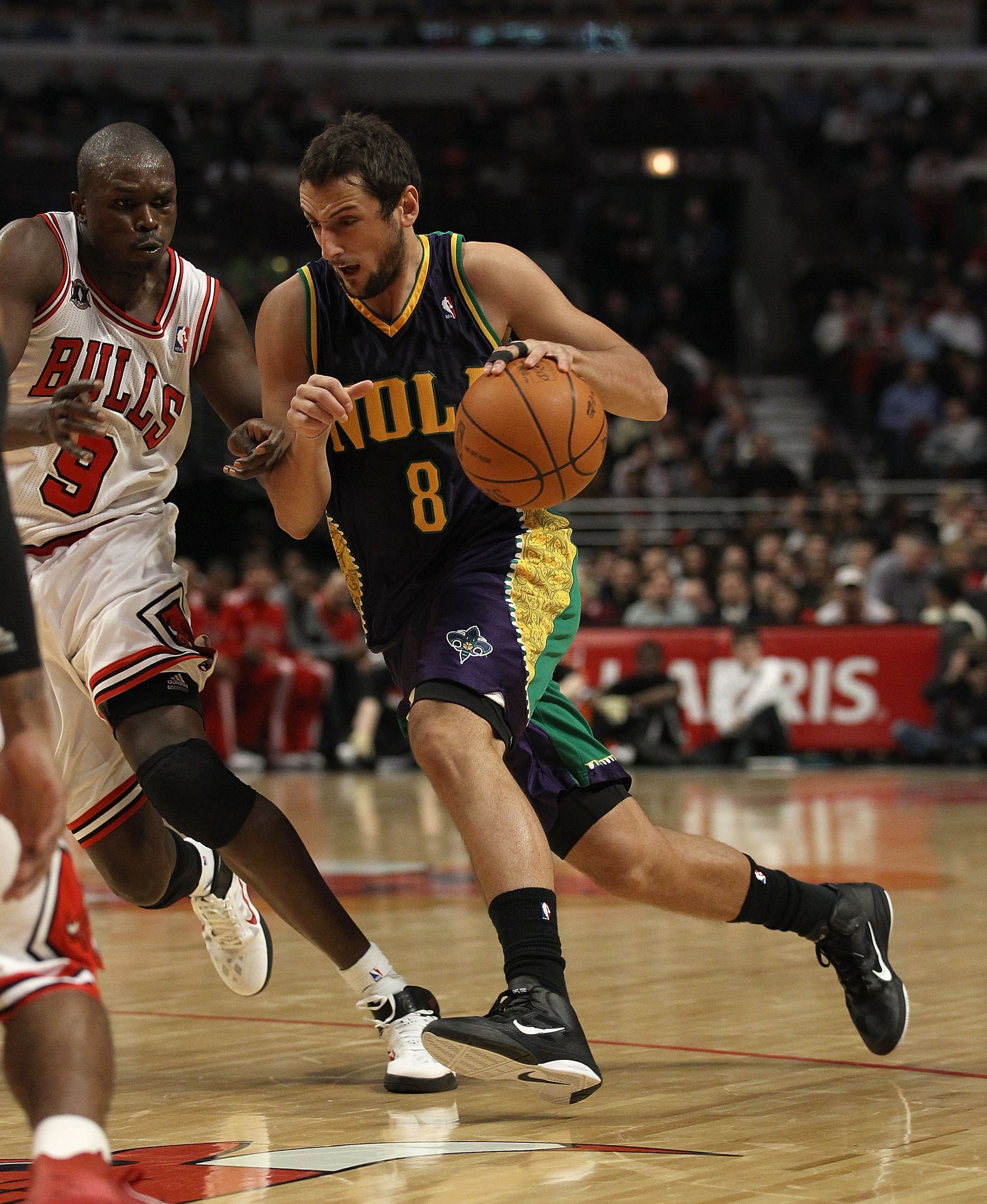CHICAGO, IL - MARCH 07: Marco Belinelli #8 of the New Orleans Hornets moves against Loul Deng #9 of the Chicago Bulls at the United Center on March 7, 2011 in Chicago, Illinois. The Bulls defeated the Hornets 85-77. NOTE TO USER: User expressly acknowledg