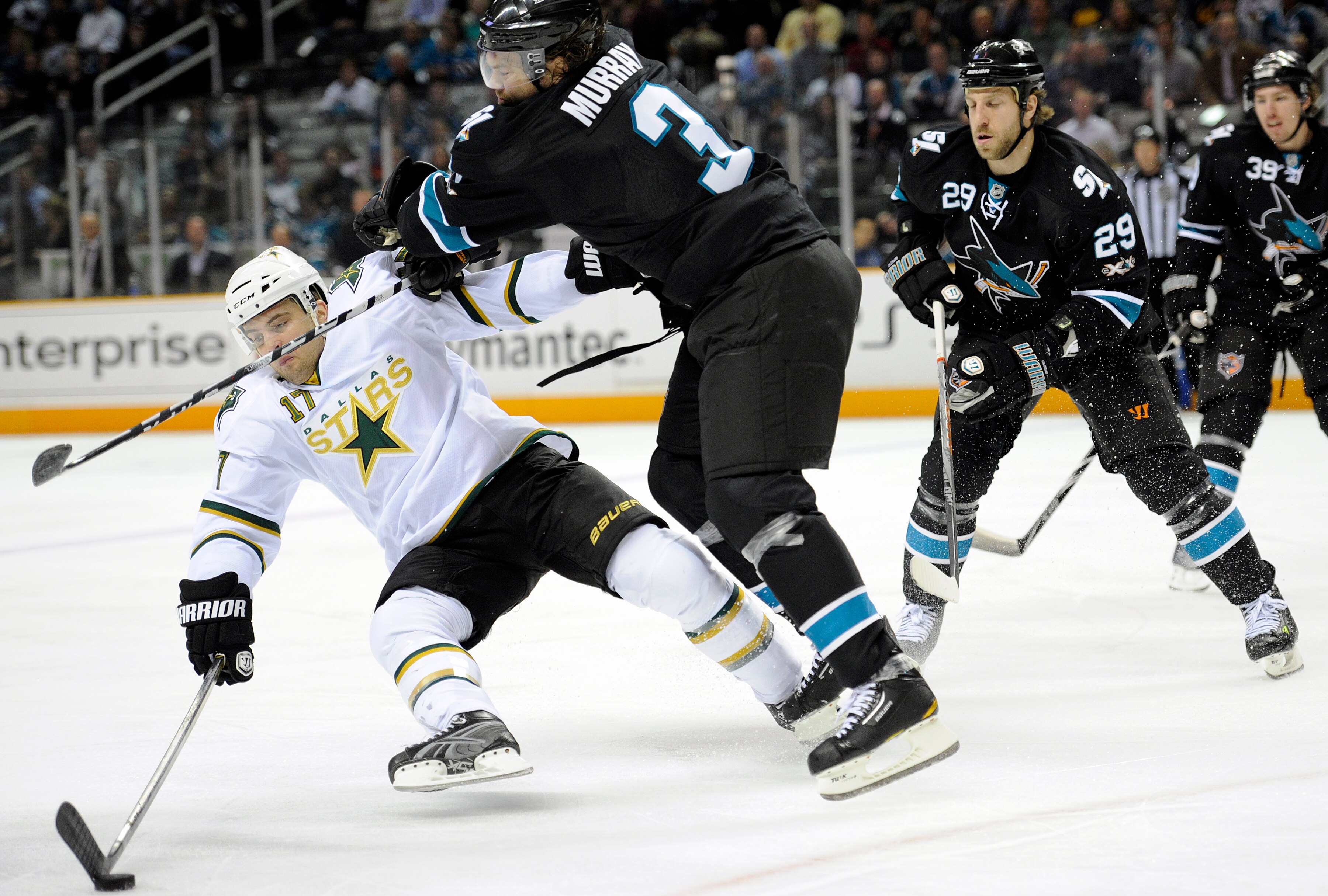 SAN JOSE, CA - MARCH 31: Toby Petersen #17 of the Dallas Stars gets knocked away from the puck by Douglas Murray #3 of the San Jose Sharks in the first period during an NHL hockey game at the HP Pavilion on March 31, 2011 in San Jose, California. (Photo b