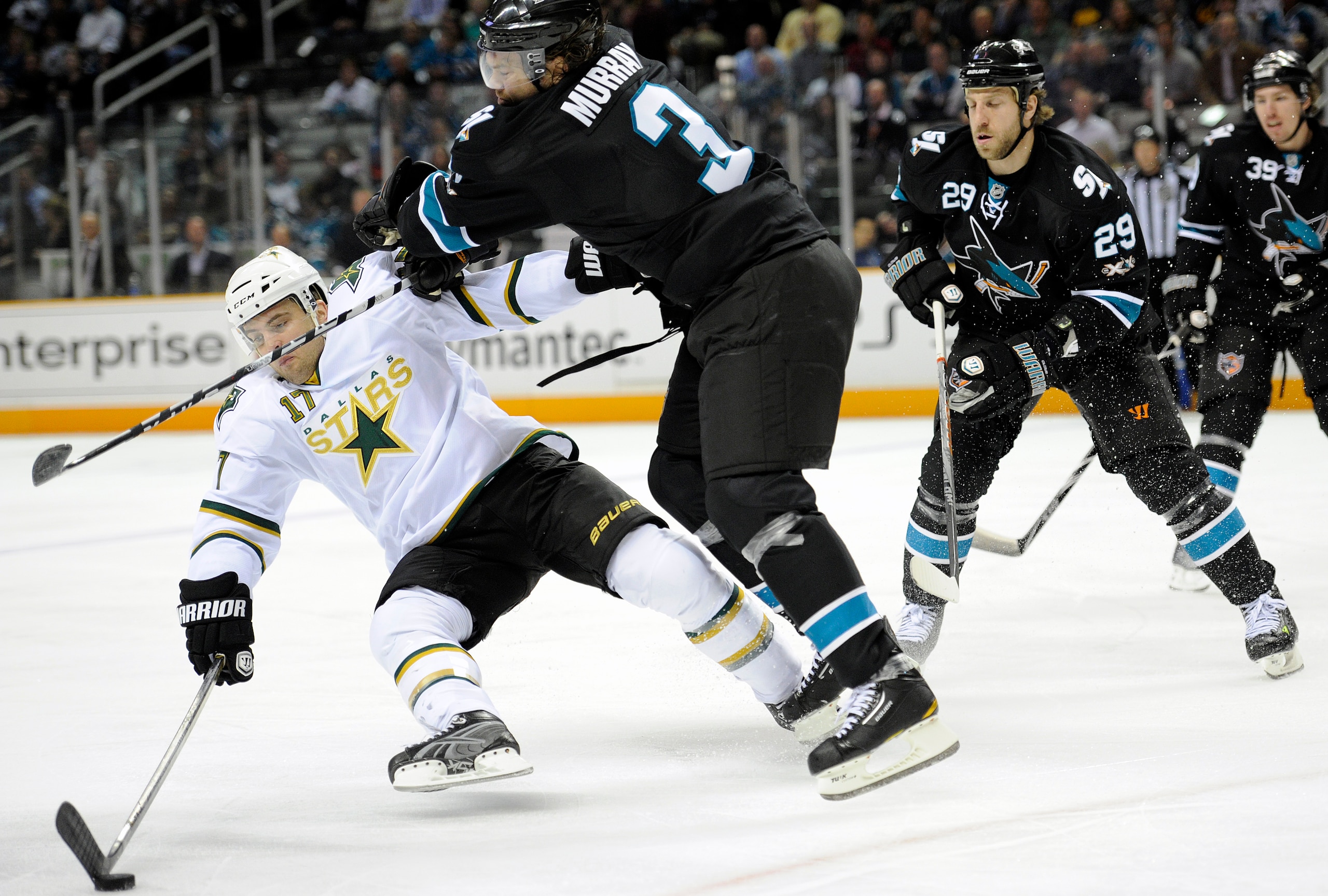SAN JOSE, CA - MARCH 31: Toby Petersen #17 of the Dallas Stars gets knocked away from the puck by Douglas Murray #3 of the San Jose Sharks in the first period during an NHL hockey game at the HP Pavilion on March 31, 2011 in San Jose, California. (Photo b