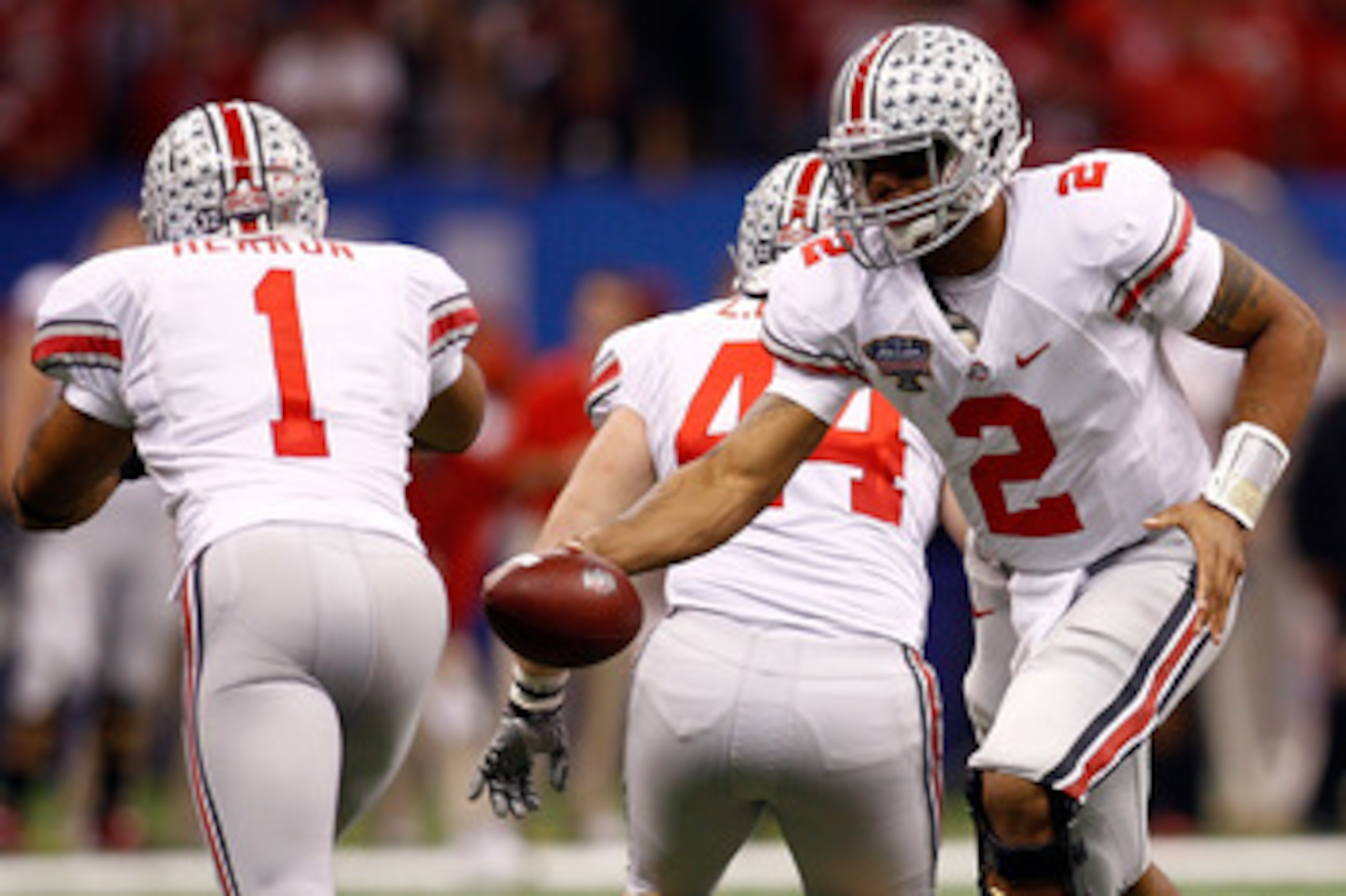 NEW ORLEANS, LA - JANUARY 04:  Quarterback Terrelle Pryor #2 of the Ohio State Buckeyes looks to hand the ball of to Dan Herron #1 against the Arkansas Razorbacks in the Sugar Bowl at the Louisiana Superdome on January 4, 2011 in New Orleans, Louisiana.