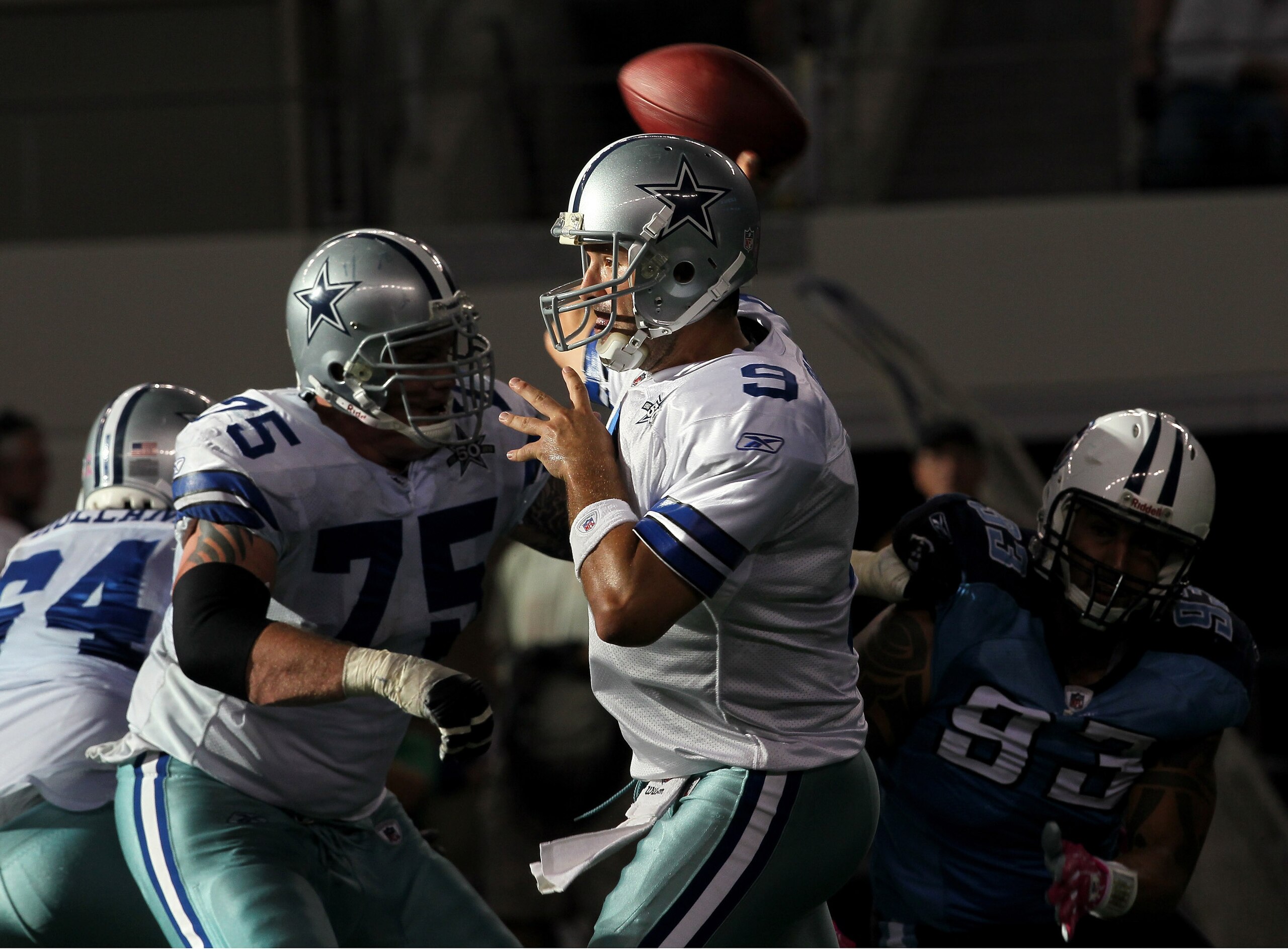 ARLINGTON, TX - OCTOBER 10:  Quarterback Tony Romo #9 of the Dallas Cowboys throws a pass behind the blocking of tackle Marc Colombo #75 against the Tennessee Titans at Cowboys Stadium on October 10, 2010 in Arlington, Texas. The Titans won 34-27.  (Photo