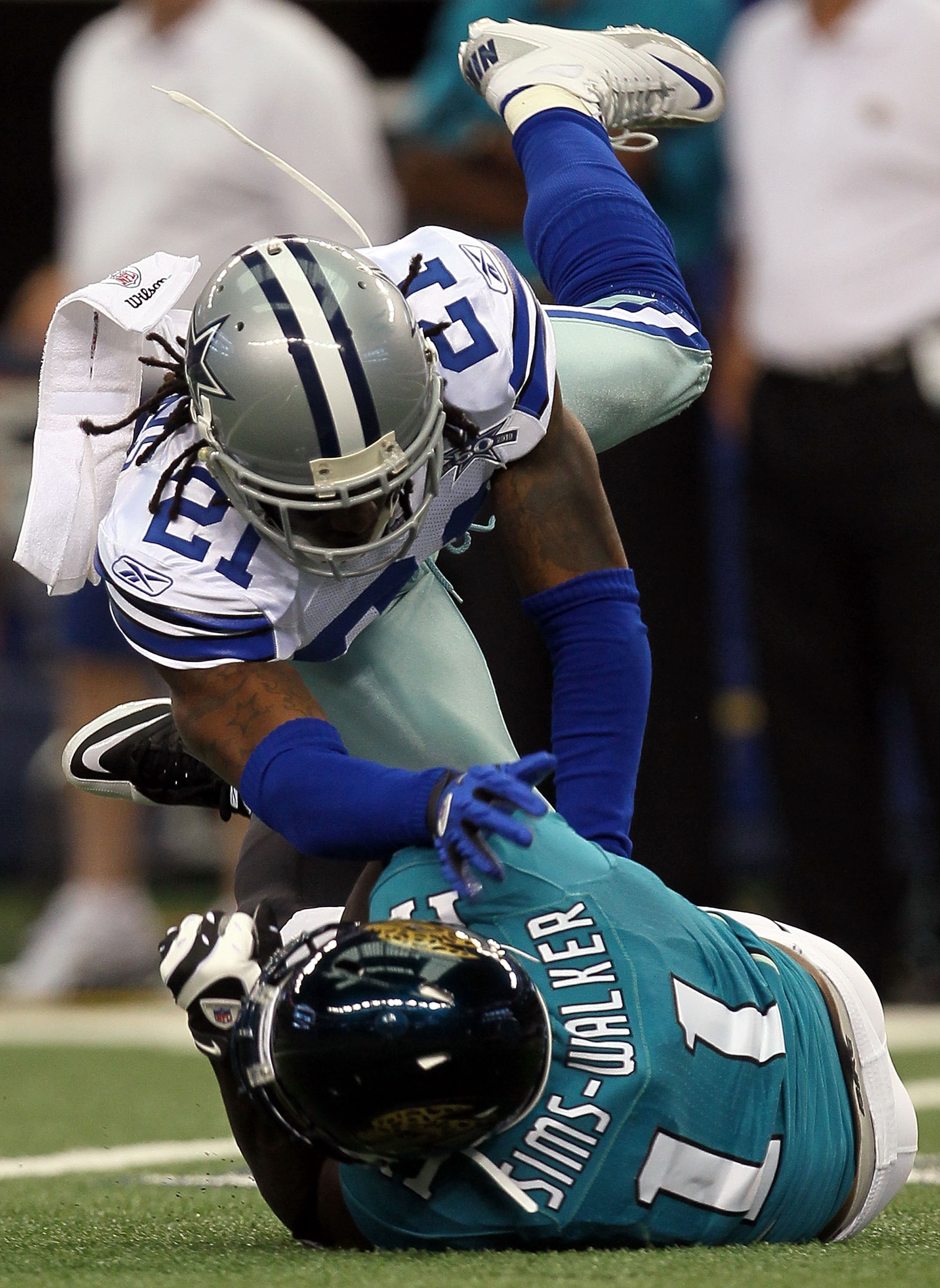 ARLINGTON, TX - OCTOBER 31:  Wide receiver Mike Sims-Walker #11 of the Jacksonville Jaguars is tackled by Mike Jenkins #21 of the Dallas Cowboys at Cowboys Stadium on October 31, 2010 in Arlington, Texas.  (Photo by Stephen Dunn/Getty Images)