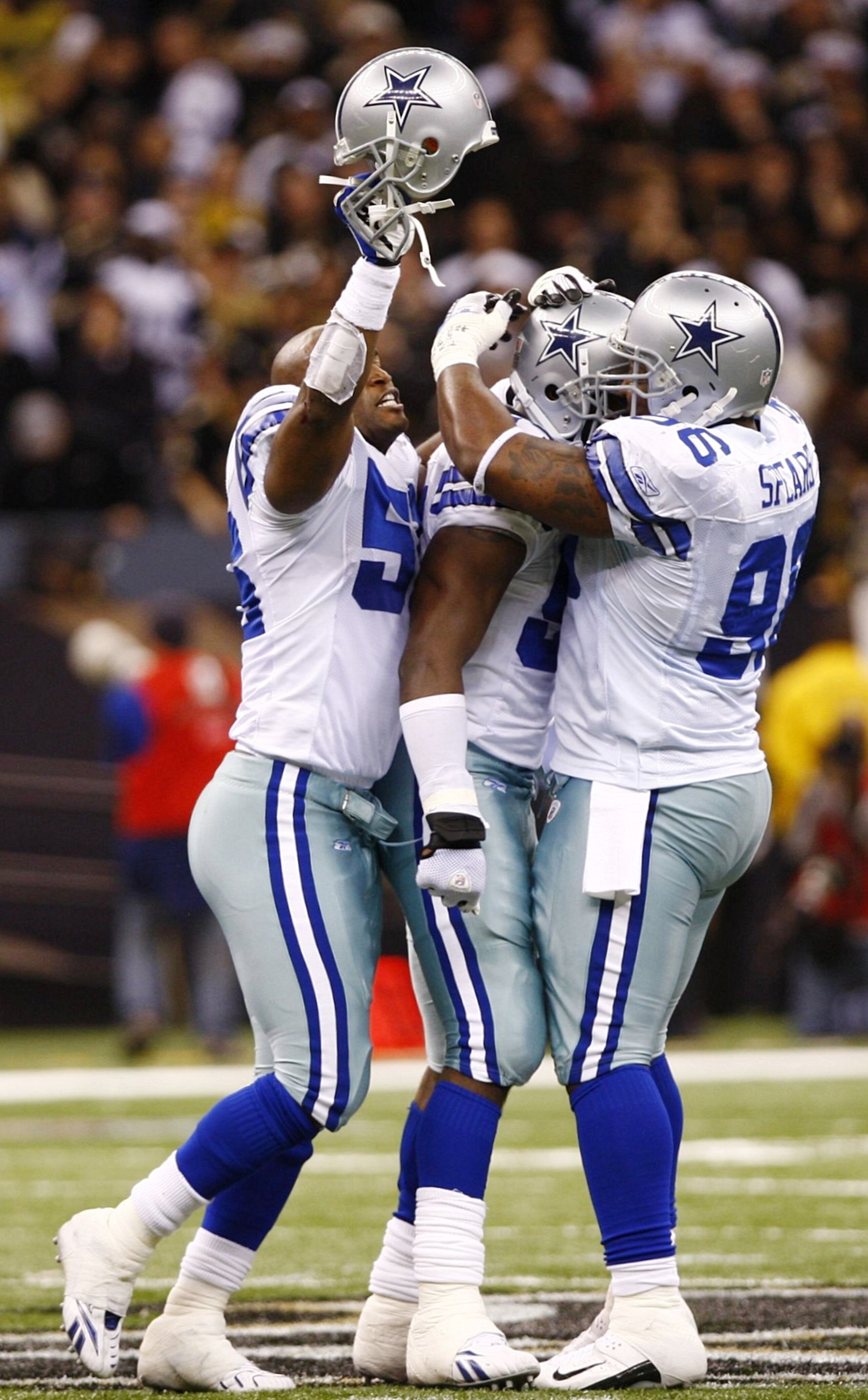 NEW ORLEANS - DECEMBER 19:  Bradie James #56, DeMarcus Ware #94 and Marcus Spears #96 of the Dallas Cowboys celebrate after Ware sacked quarterback Drew Brees #9 of the New Orleans Saints to end the game at the Louisiana Superdome on December 19, 2009 in