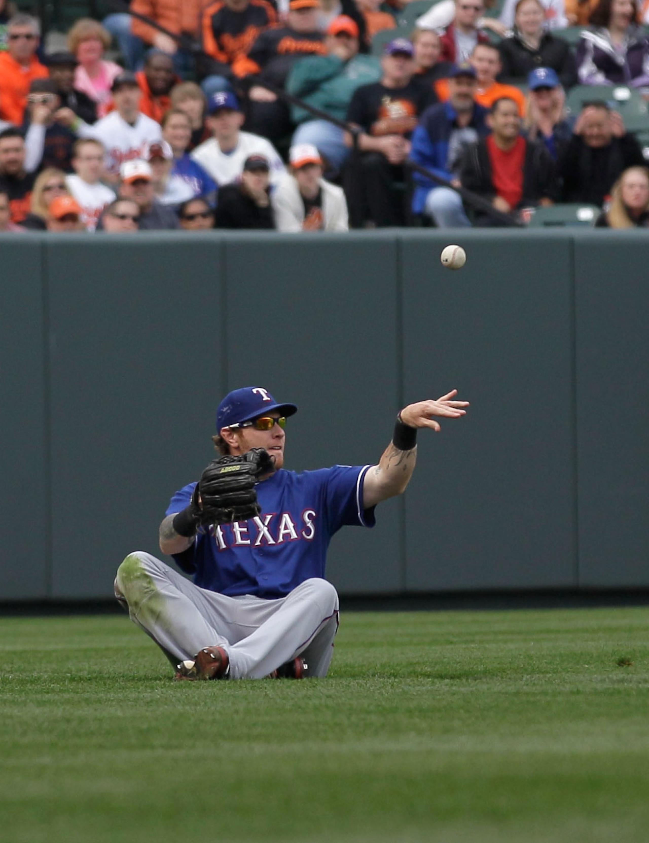 BALTIMORE, MD - APRIL 10: Left fielder Josh Hamilton #32 of the Texas Rangers flips the ball back against the Baltimore Orioles at Oriole Park at Camden Yards on April 10, 2011 in Baltimore, Maryland.  (Photo by Rob Carr/Getty Images)
