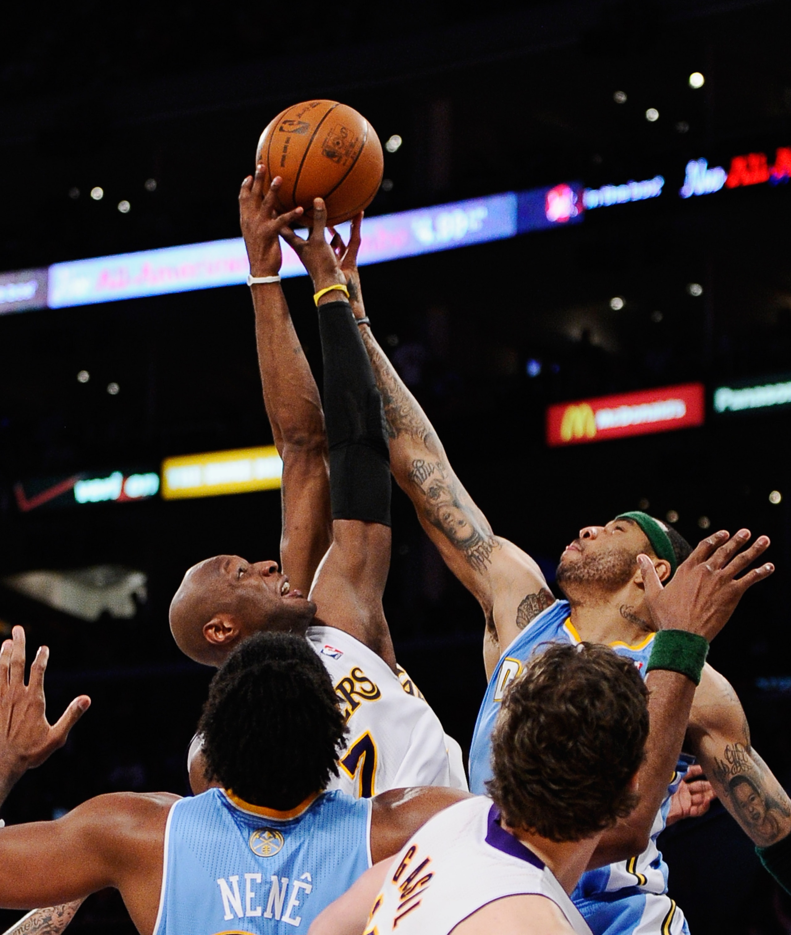LOS ANGELES, CA - APRIL 03:  Kenyon Martin #4 of the Denver Nuggets and Lamar Odom #7 of the Los Angeles Lakers battle for a rebound during the game at Staples Center on April 3, 2011 in Los Angeles, California. NOTE TO USER: User expressly acknowledges a