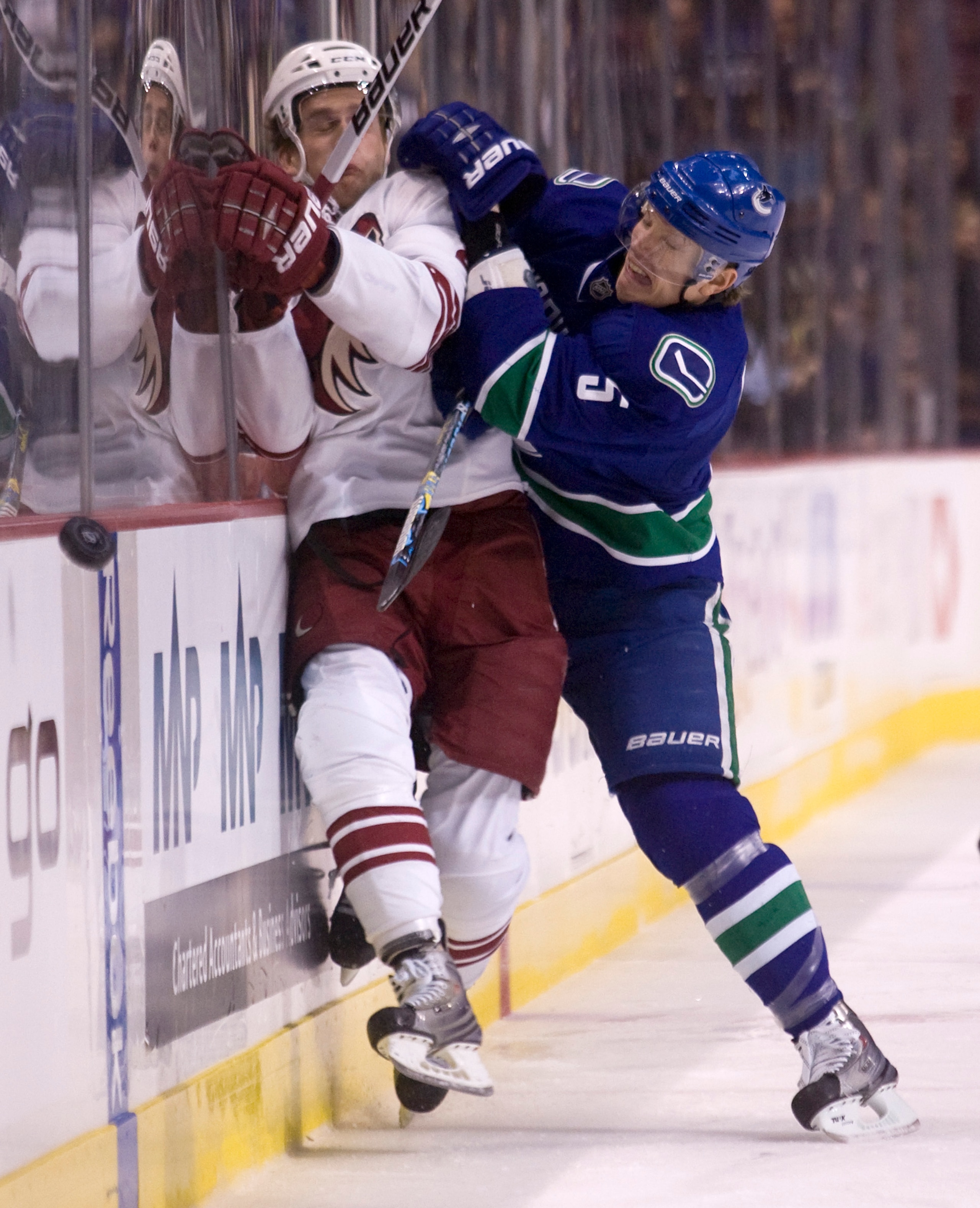 VANCOUVER, CANADA - JANUARY 7: Christian Ehrhoff #5 of the Vancouver Canucks hits Lauri Korpikoski #29 of the Phoenix Coyotes into the side boards during the first period of NHL action on January 07, 2010 at General Motors Place in Vancouver, British Colu VANCOUVER, CANADA - JANUARY 7: Christian Ehrhoff #5 of the Vancouver Canucks hits Lauri Korpikoski #29 of the Phoenix Coyotes into the side boards during the first period of NHL action on January 07, 2010 at General Motors Place in Vancouver, British Colu