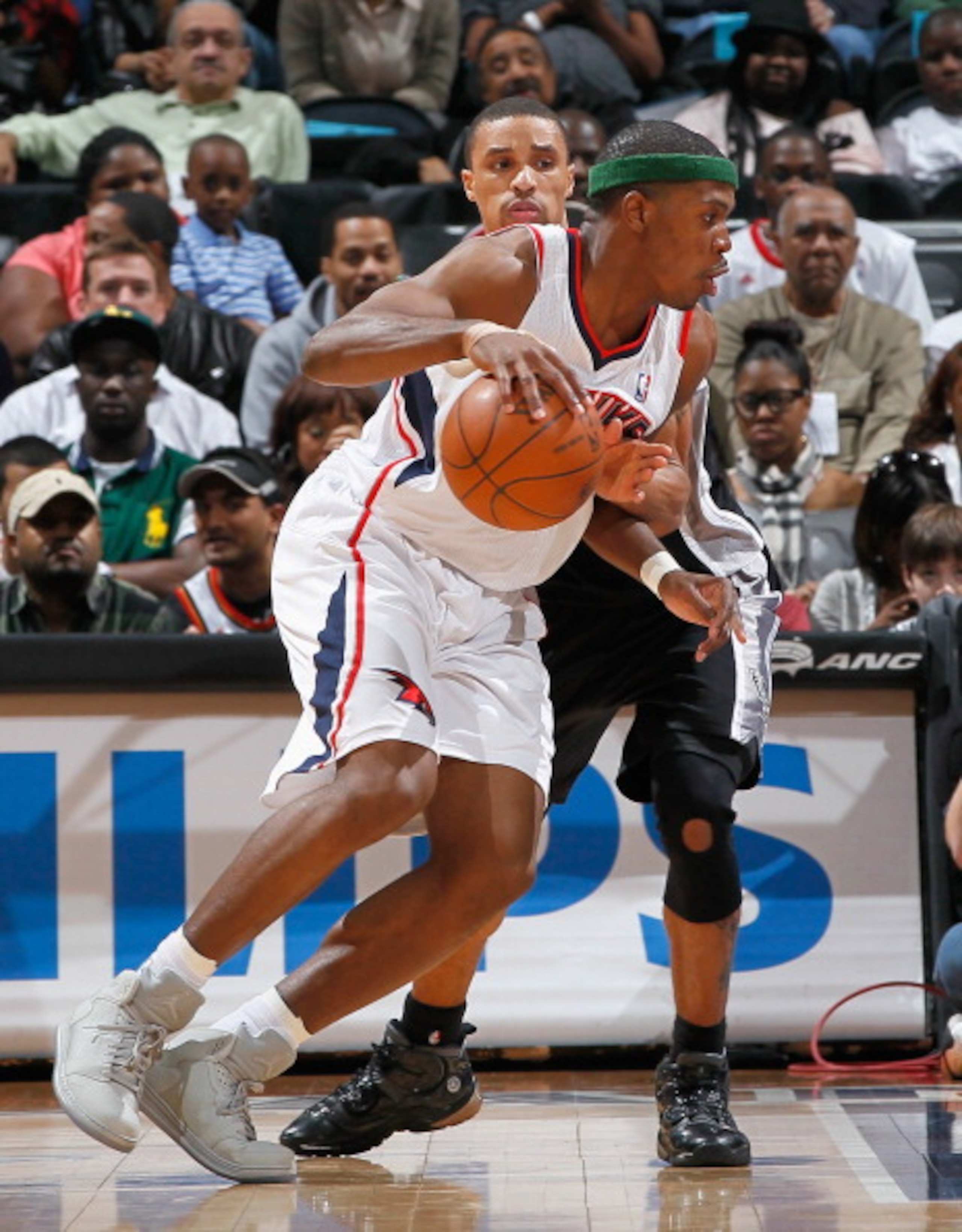 ATLANTA, GA - APRIL 05:  Joe Johnson #2 of the Atlanta Hawks against George Hill #3 of the San Antonio Spurs at Philips Arena on April 5, 2011 in Atlanta, Georgia.  NOTE TO USER: User expressly acknowledges and agrees that, by downloading and/or using thi