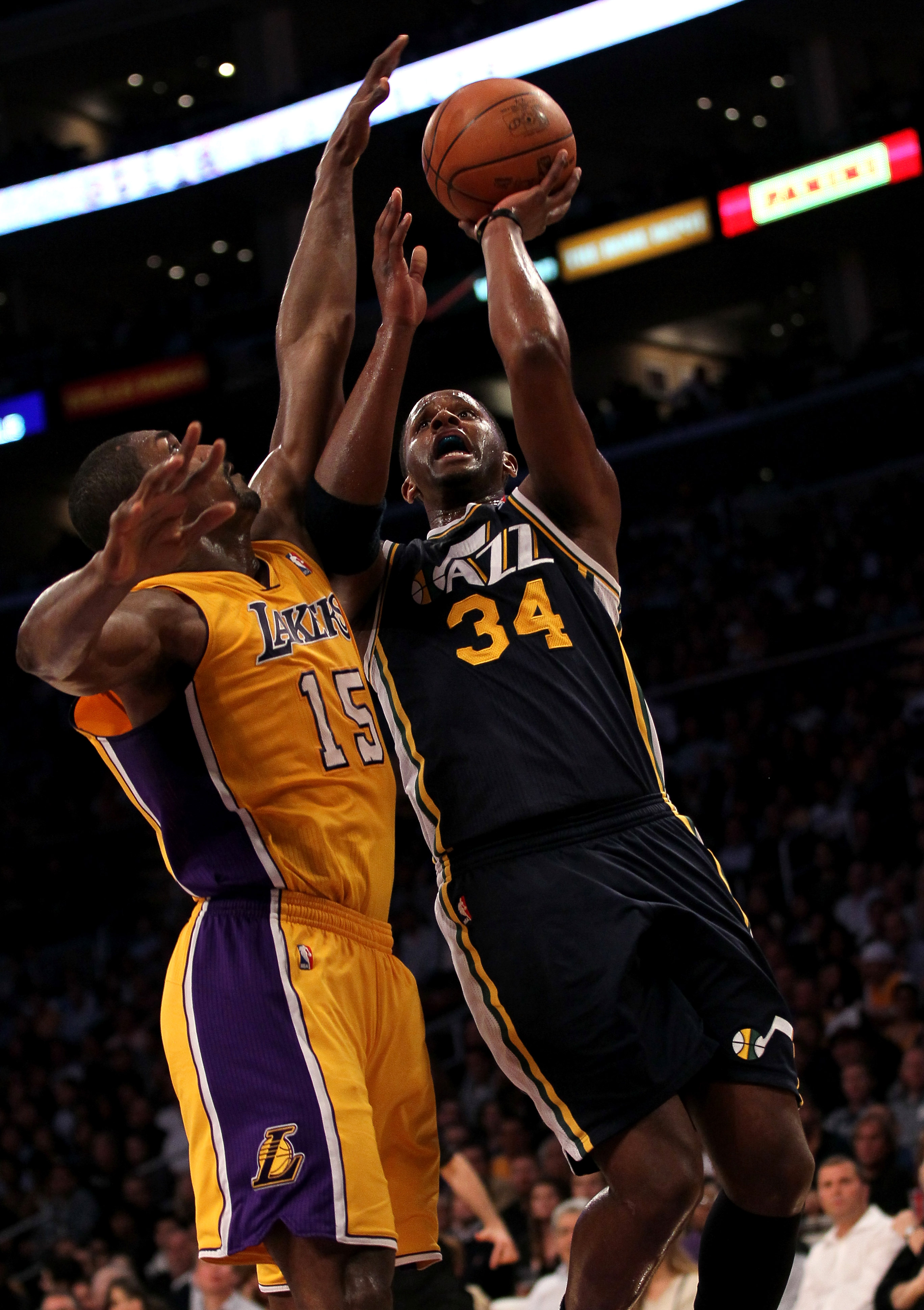 LOS ANGELES, CA - APRIL 05:  C.J. Miles #34 of the Utah Jazz goes up for a shot against Ron Artest #15 of the Los Angeles Lakers at Staples Center on April 5, 2011 in Los Angeles, California.  NOTE TO USER: User expressly acknowledges and agrees that, by