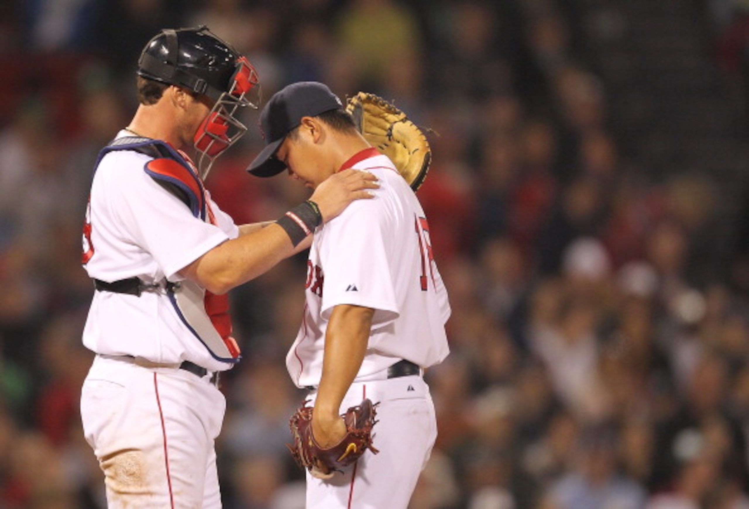 BOSTON, MA - APRIL 11:  Jarrod Saltalamacchia #39 consoles Daisuke Matsuzaka #18 of the Boston Red Sox after a six-run second inning against the Tampa Bay Rays at Fenway Park April 11, 2011 in Boston, Massachusetts. (Photo by Jim Rogash/Getty Images)