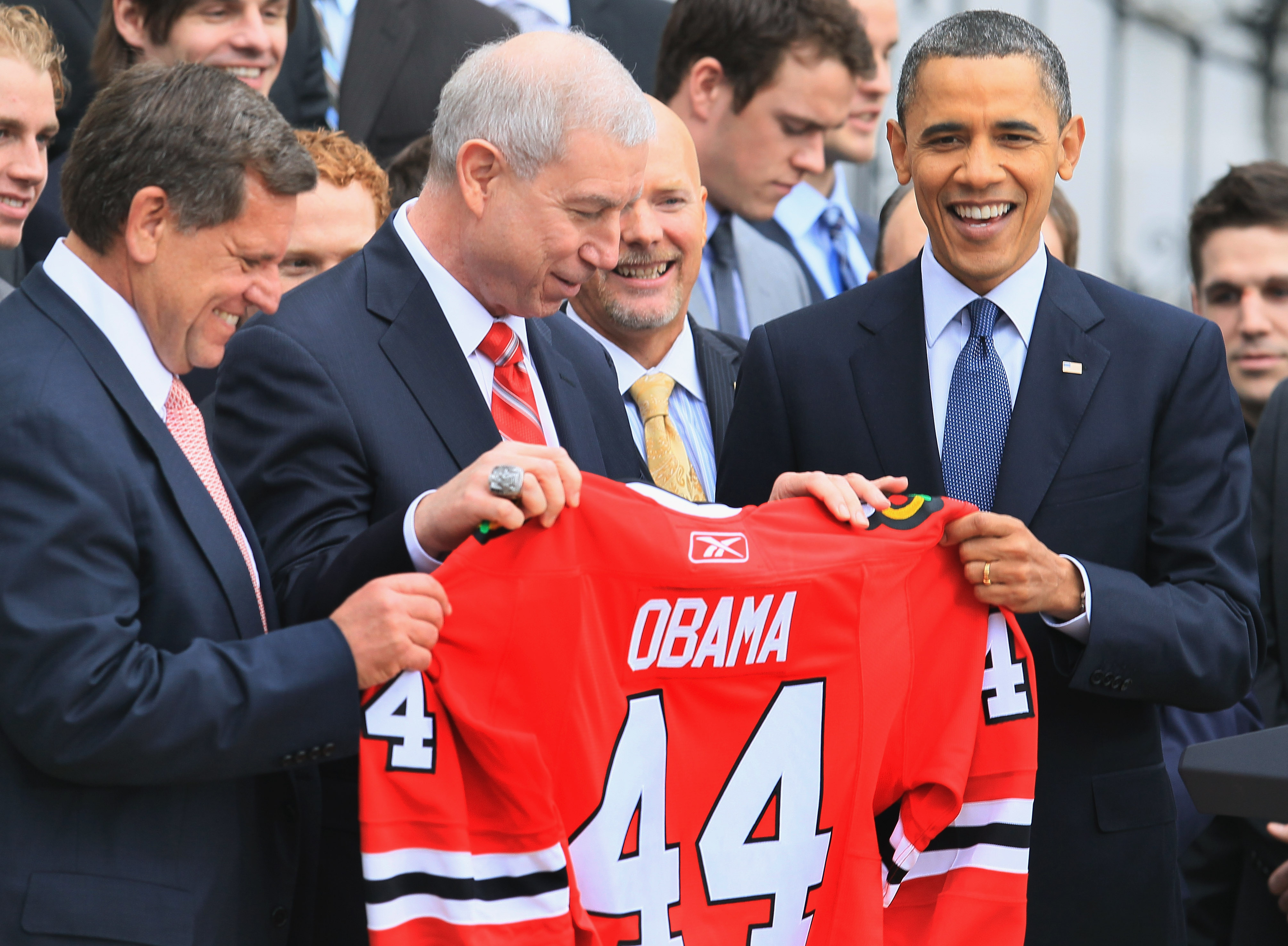 WASHINGTON, DC - MARCH 11:  U.S. President Barack Obama (R) is presented with a hockey jersey by Chicago Blackhawks President, John McDonough (C), during an event on the south lawn of the White House on March 11, 2011 in Washington, DC.  Obama hosted the