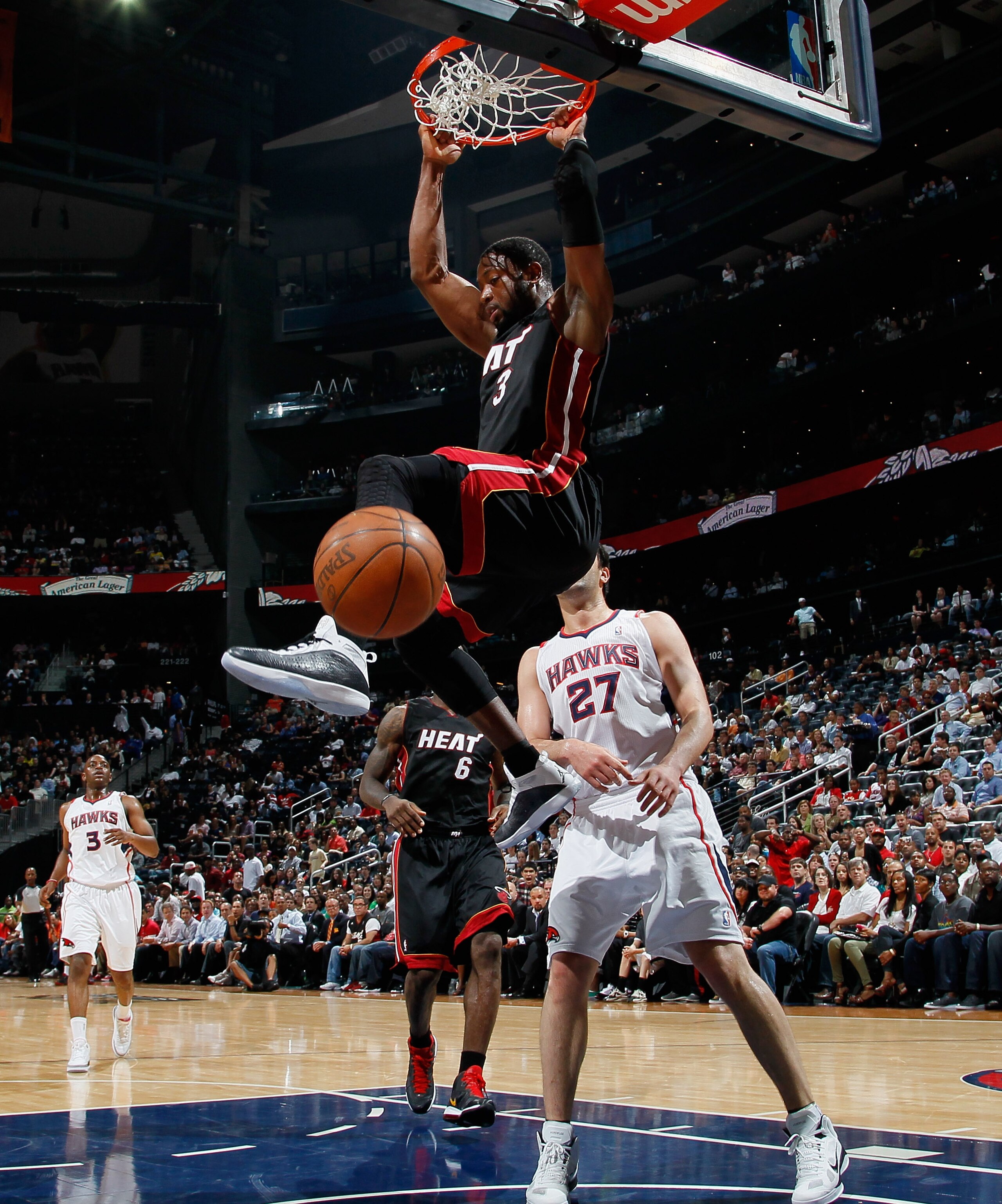 ATLANTA, GA - APRIL 11:  Dwyane Wade #3 of the Miami Heat dunks against Zaza Pachulia #27 of the Atlanta Hawks at Philips Arena on April 11, 2011 in Atlanta, Georgia.  NOTE TO USER: User expressly acknowledges and agrees that, by downloading and/or using
