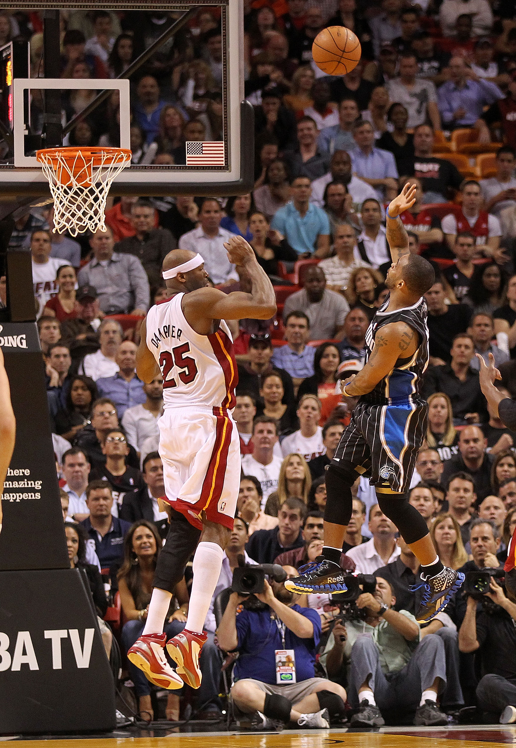 MIAMI, FL - MARCH 03:  Jameer Nelson #14 of the Orlando Magic shoots over Eric Dampier #25 of the Miami Heat during a game at American Airlines Arena on March 3, 2011 in Miami, Florida. NOTE TO USER: User expressly acknowledges and agrees that, by downloa