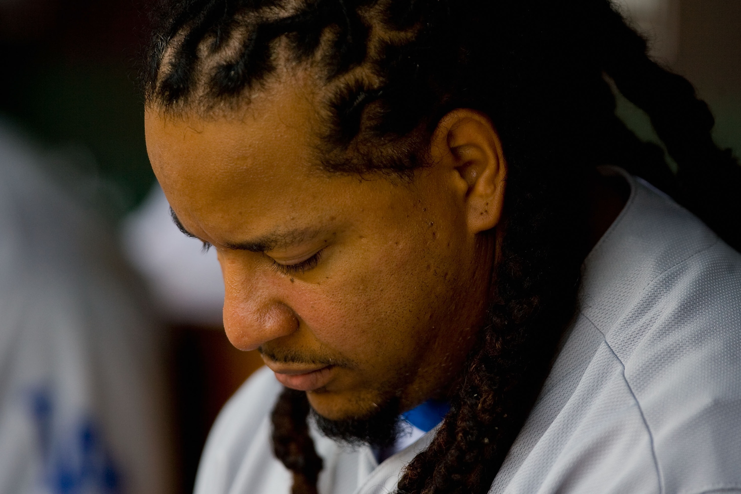 ST. LOUIS - JULY 18: Manny Ramirez #99 of the Los Angeles Dodgers sits in the dugout against the St. Louis Cardinals at Busch Stadium on July 18, 2010 in St. Louis, Missouri.  (Photo by Dilip Vishwanat/Getty Images)