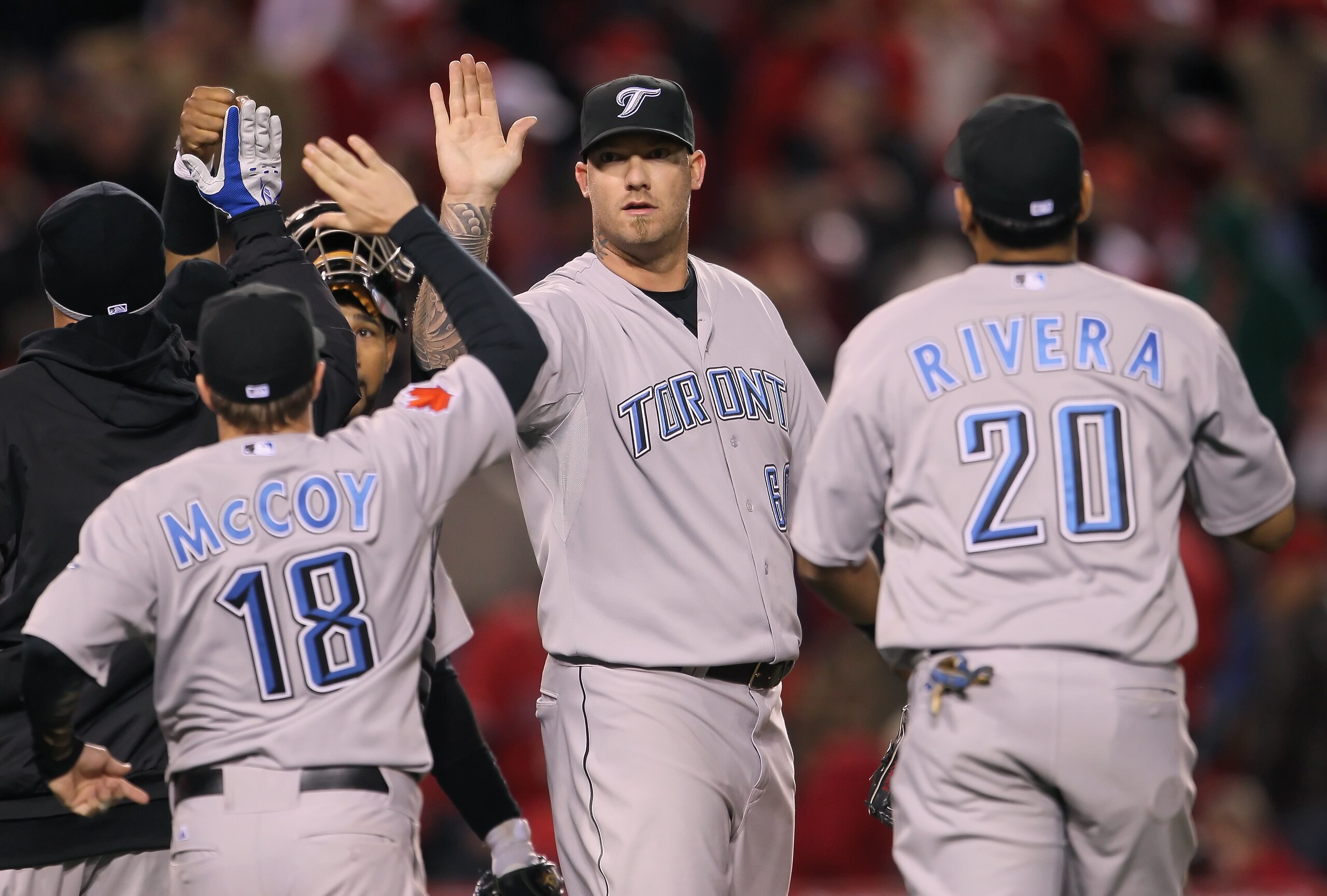 ANAHEIM, CA - APRIL 08:  Closing pitcher Jon Rauch #60 of the Toronto Blue Jays receives high fives from his teammates after saving the game against the Los Angeles Angels of Anaheim at Angel Stadium of Anaheim on April 8, 2011 in Anaheim, California. The