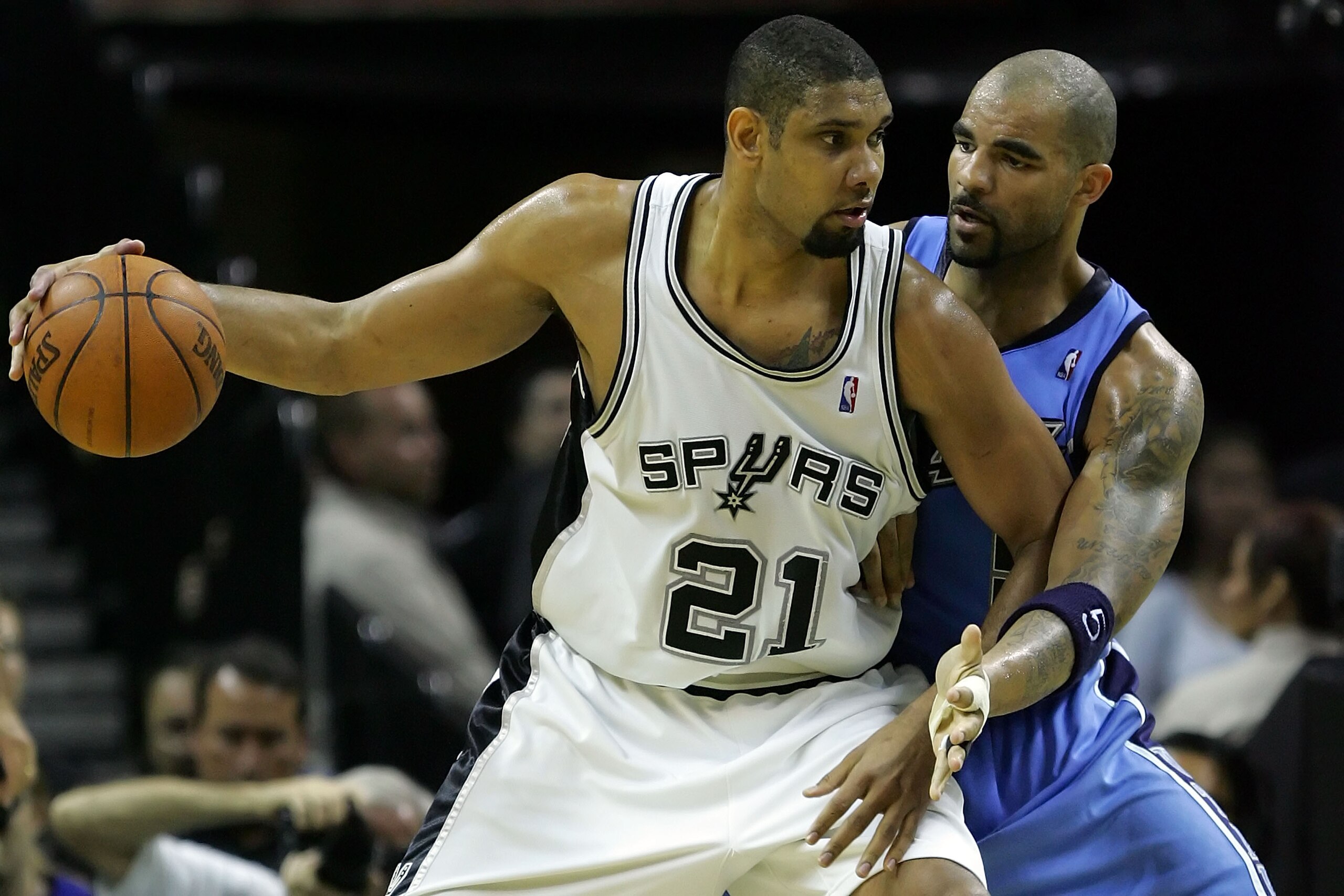 SAN ANTONIO - MAY 30:  Tim Duncan #21 of the San Antonio Spurs posts up Carlos Boozer #5 of the Utah Jazz in the second quarter during Game Five of the Western Conference Finals during the 2007 NBA Playoffs at AT&T Center on May 30, 2007 in San Antonio, T