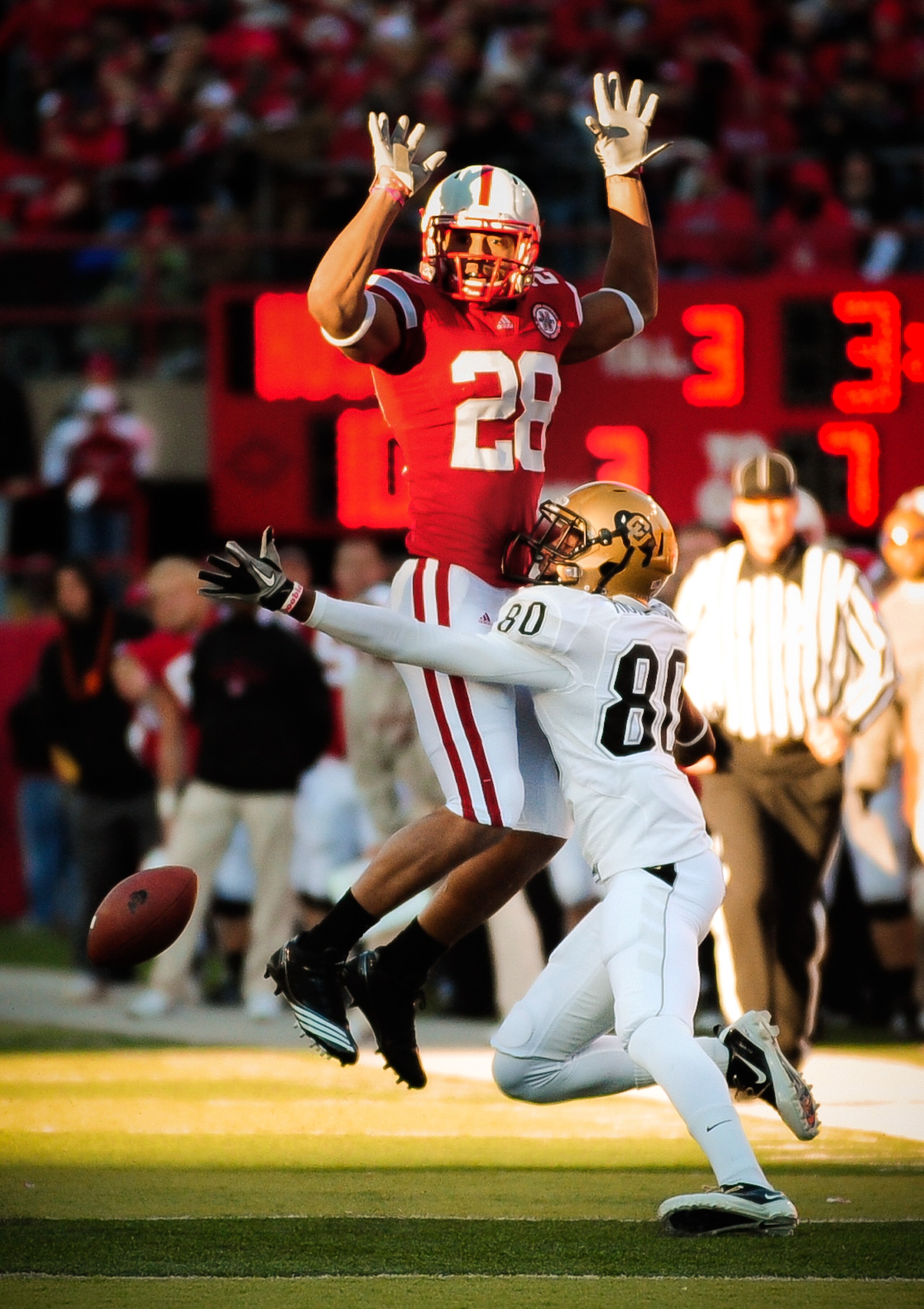 LINCOLN, NE - NOVEMBER 26: Eric Hagg #28 of the Nebraska Cornhuskers attempts to not interfere with Paul Richardson #80 of the Colorado Buffaloes during their game at Memorial Stadium on November 26, 2010 in Lincoln, Nebraska. Nebraska defeated Colorado 4