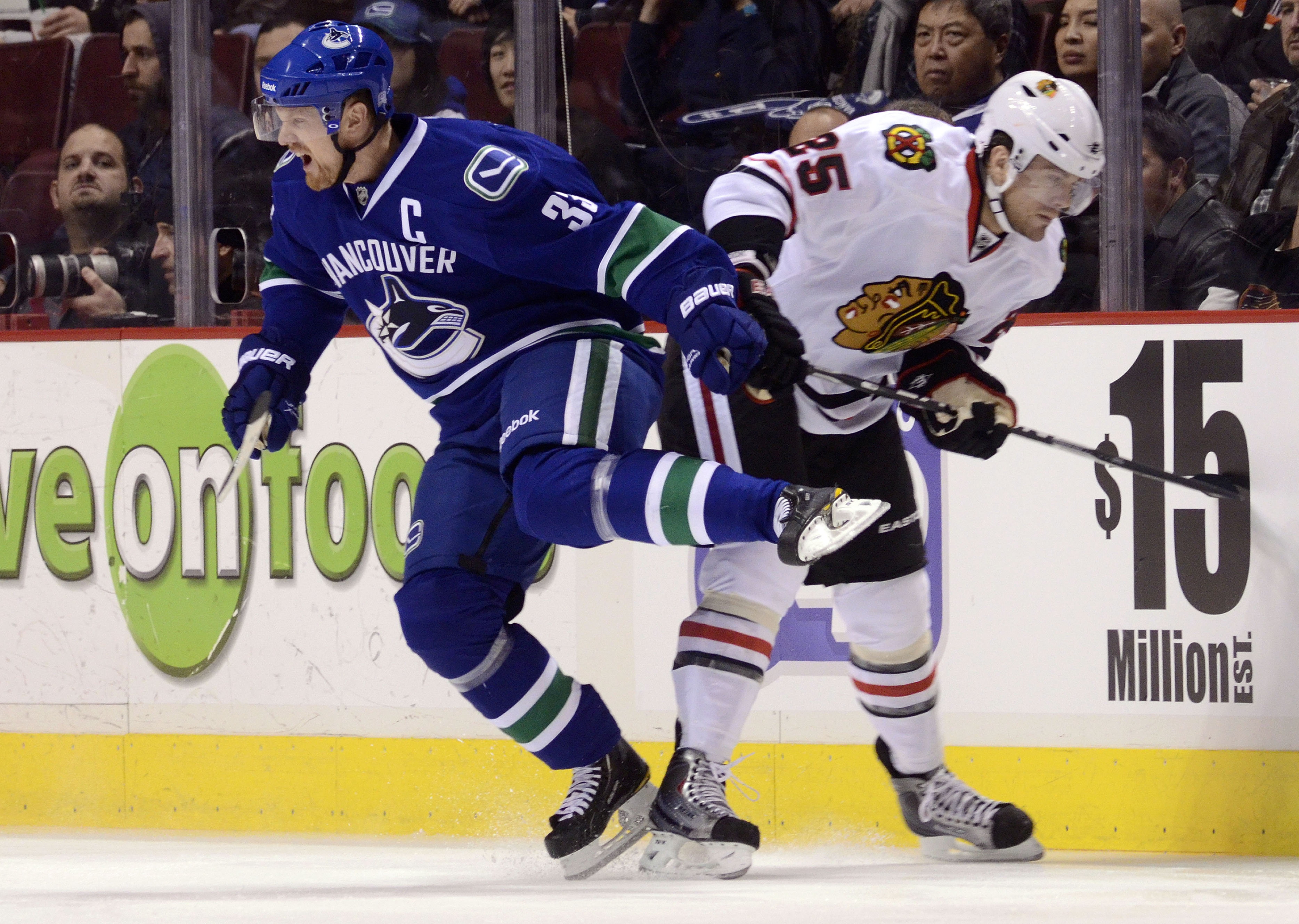 VANCOUVER, CANADA - FEBRUARY 4: Henrik Sedin #33 of the Vancouver Canucks reacts after colliding with Viktor Stalberg #25 of the Chicago Blackhawks during the first period in NHL action on February 04, 2011 at Rogers Arena in Vancouver, British Columbia, 