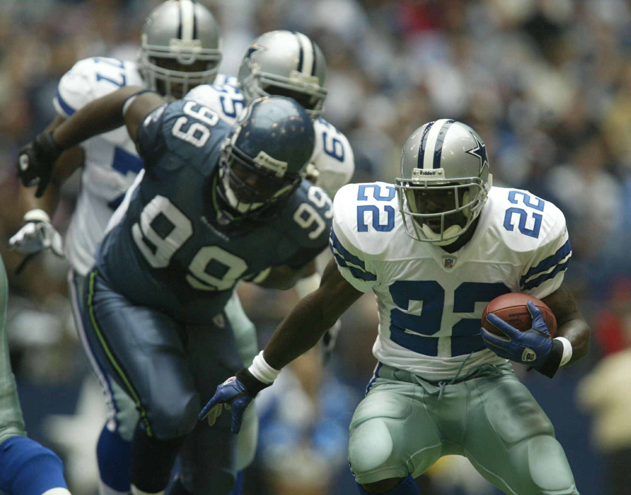 IRVING, TX - OCTOBER 27:  Emmitt Smith #22 of the Dallas Cowboys carries the ball as Rocky Bernard #99 of the Seattle Seahawks pursues on October 27, 2002 at Texas Stadium in Irving, Texas.  Smith later set the NFL all time rushing record, but the Seahawk
