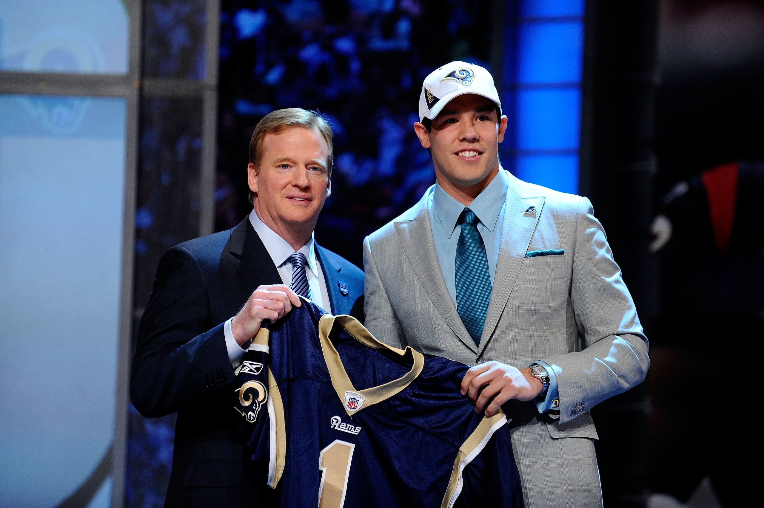 NEW YORK - APRIL 22:  Quarterback Sam Bradford (R) from the Oklahoma Sooners poses with NFL Commissioner Roger Goodell as they hold up a St. Louis Rams jersey after the Rams selected Bradford numer 1 overall during the first round of the 2010 NFL Draft at