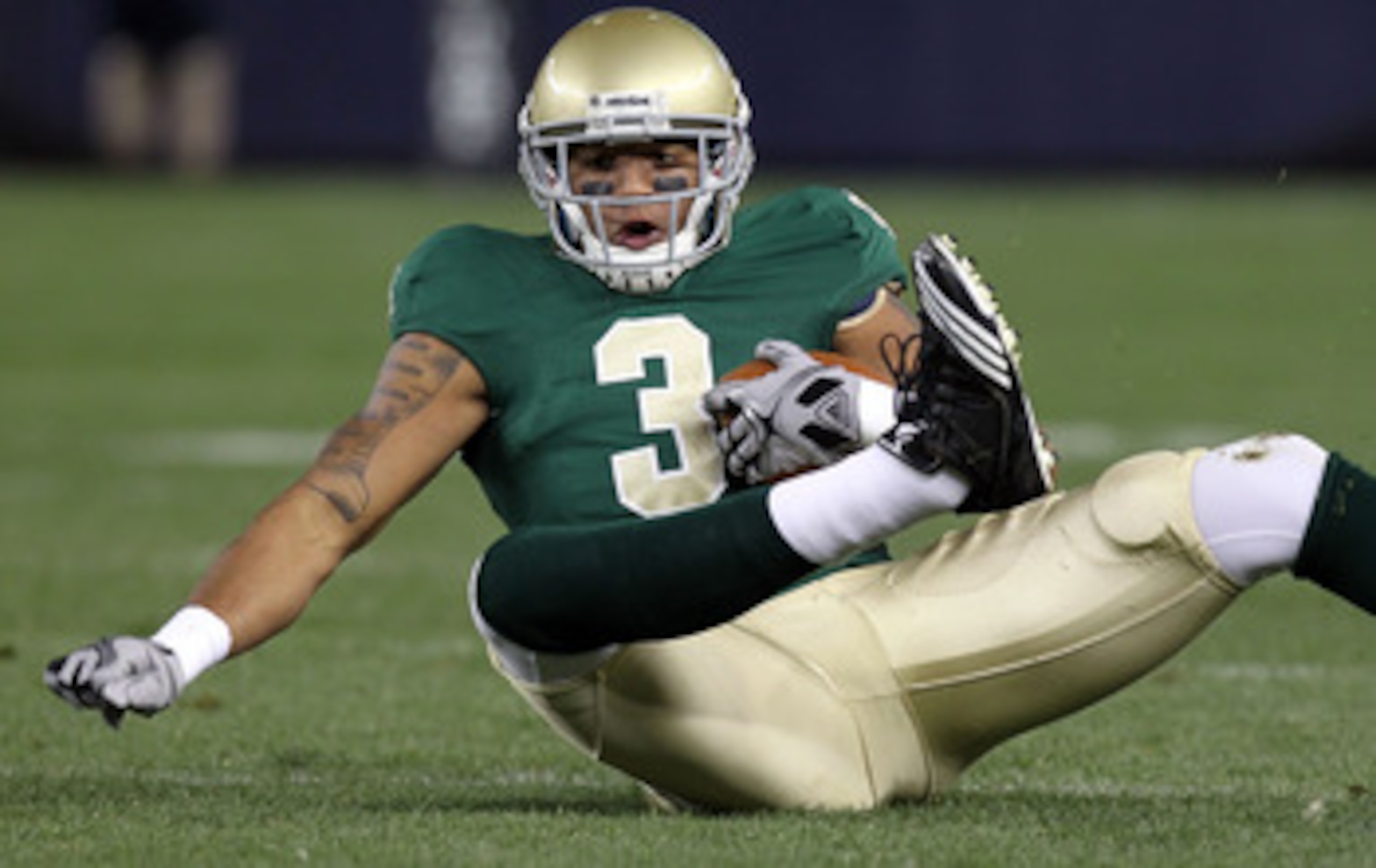 NEW YORK - NOVEMBER 20:  Michael Floyd #3 of the Notre Dame Fighting Irish loses his footing against the Army Black Knights at Yankee Stadium on November 20, 2010 in the Bronx borough of New York City.  (Photo by Nick Laham/Getty Images)