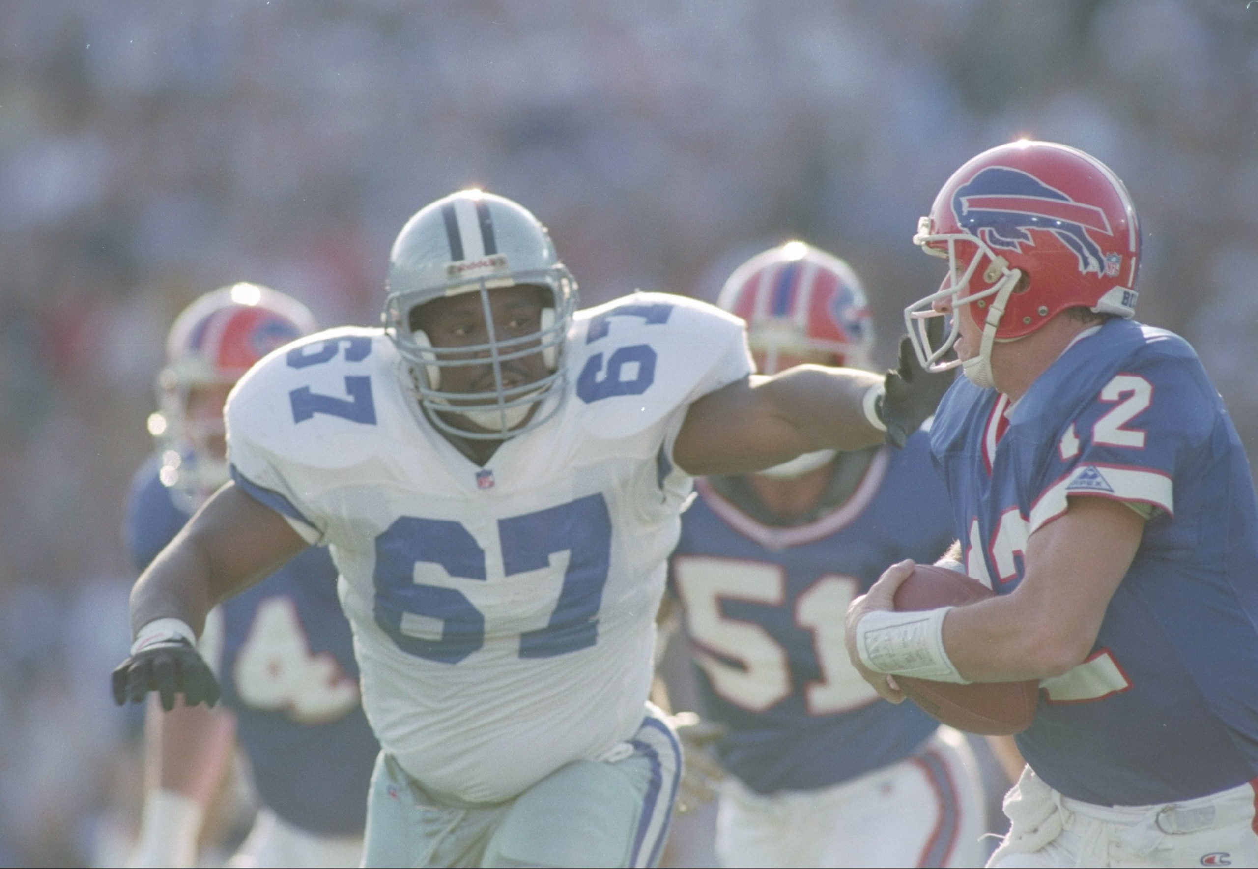 31 Jan 1993:  Defensive lineman Russell Maryland #67 of the Dallas Cowboys pressures quarterback Jim Kelly (right) of the Buffalo Bills to   surrender the ball during a Super Bowl XXVII game at the Rose Bowl in Pasadena, California.  The Cowboys won over