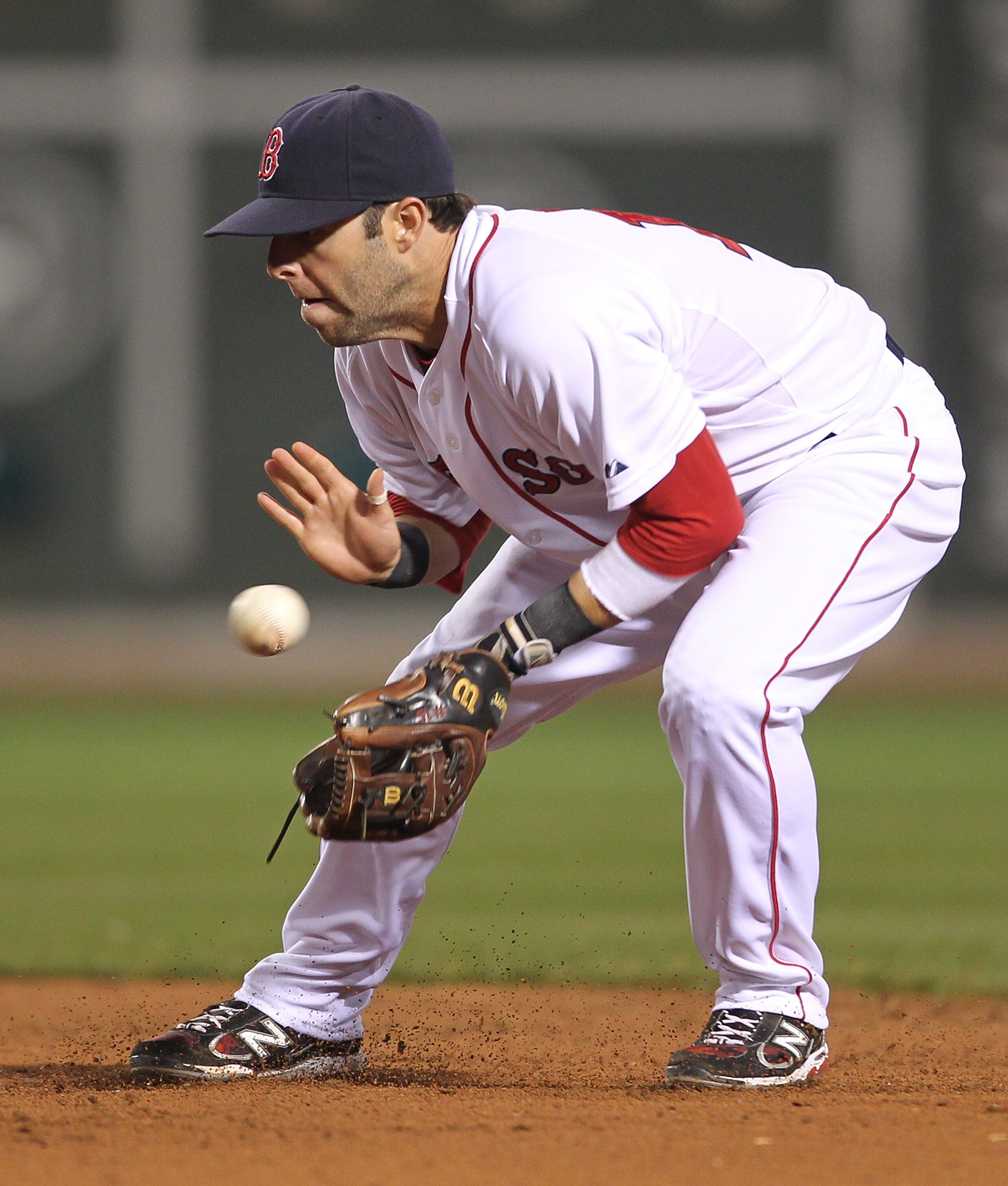 BOSTON, MA - APRIL 11:  Dustin Pedroia #15 of the Boston Red Sox makes an assist against the Tampa Bay Rays at Fenway Park April 11, 2011 in Boston, Massachusetts. (Photo by Jim Rogash/Getty Images)