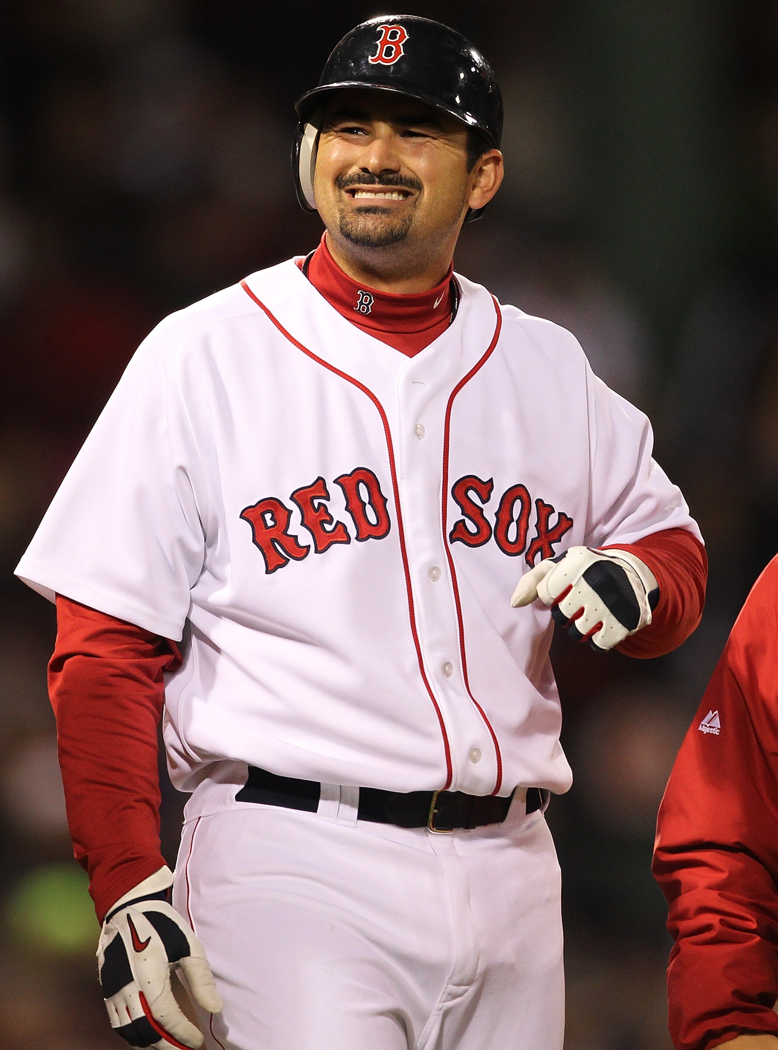 BOSTON, MA - APRIL 10:  Adrian Gonzalez #28 of the Boston Red Sox reacts after being hit by a pitch against the New York Yankees at Fenway Park April 10, 2011 in Boston, Massachusetts. (Photo by Jim Rogash/Getty Images)