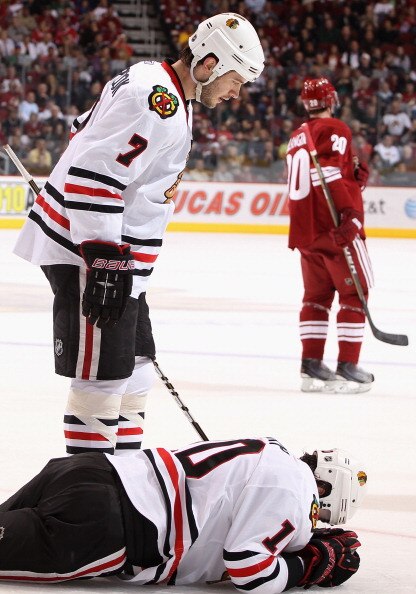 GLENDALE, AZ - MARCH 20:  Patrick Sharp #10 of the Chicago Blackhawks lays on the ice after an injury as Brent Seabrook #7 looks down during the first period of the NHL game against the Phoenix Coyotes at Jobing.com Arena on March 20, 2011 in Glendale, Ar