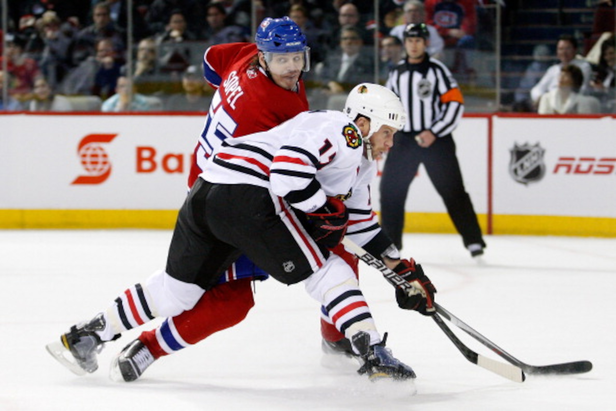 MONTREAL, CANADA - APRIL 5:  Brent Sopel #55 of the Montreal Canadiens defends against Ryan Johnson #17 of the Chicago Blackhawks during the NHL game at the Bell Centre on April 5, 2011 in Montreal, Quebec, Canada.  (Photo by Richard Wolowicz/Getty Images