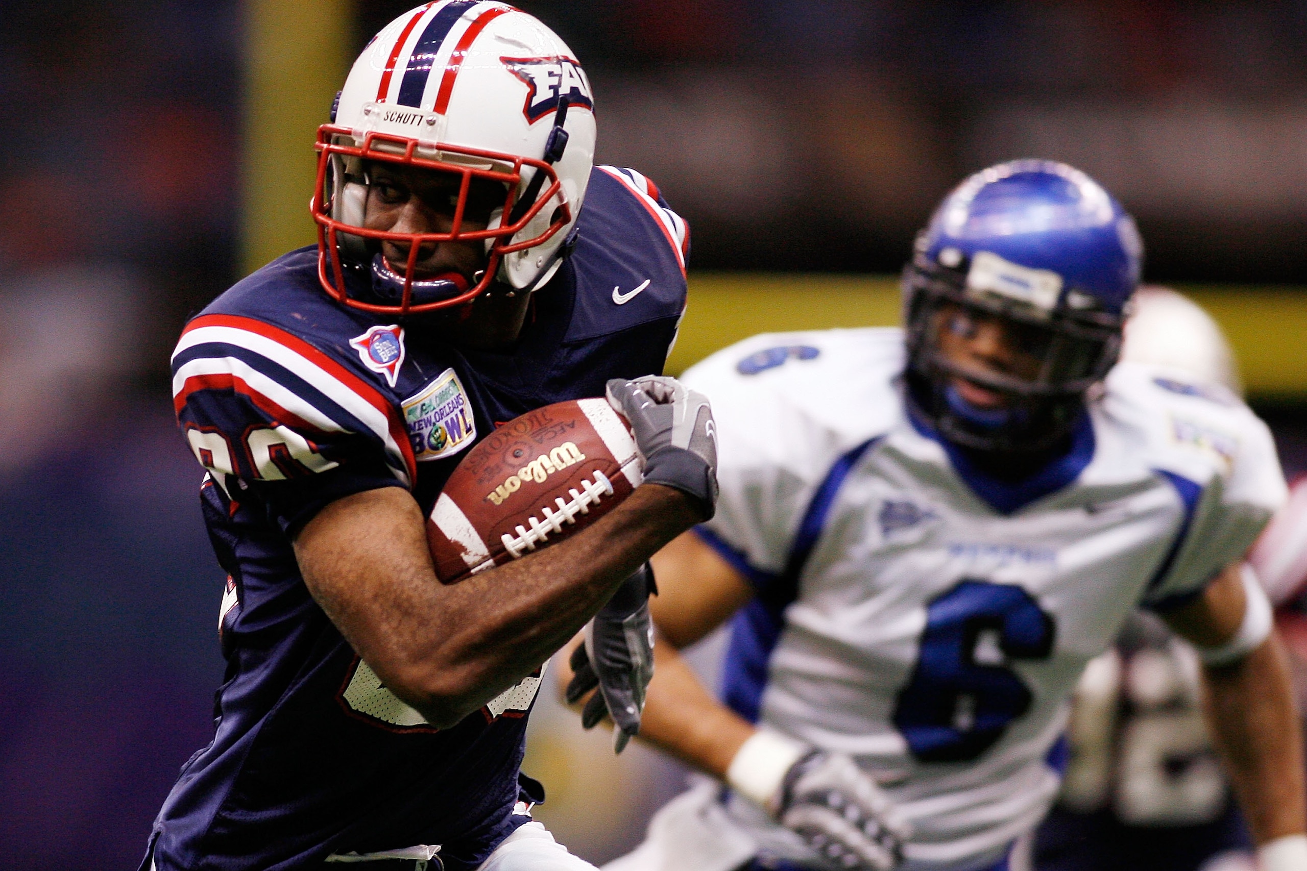 NEW ORLEANS - DECEMBER 21:  Lester Jean #80 of the Florida Atlantic University Owls avoids a tackle by Dontae Reed #6 of the Memphis University Tigers  in the New Orleans Bowl on December 21, 2007 at the Louisiana Superdome in New Orleans, Louisiana.  The