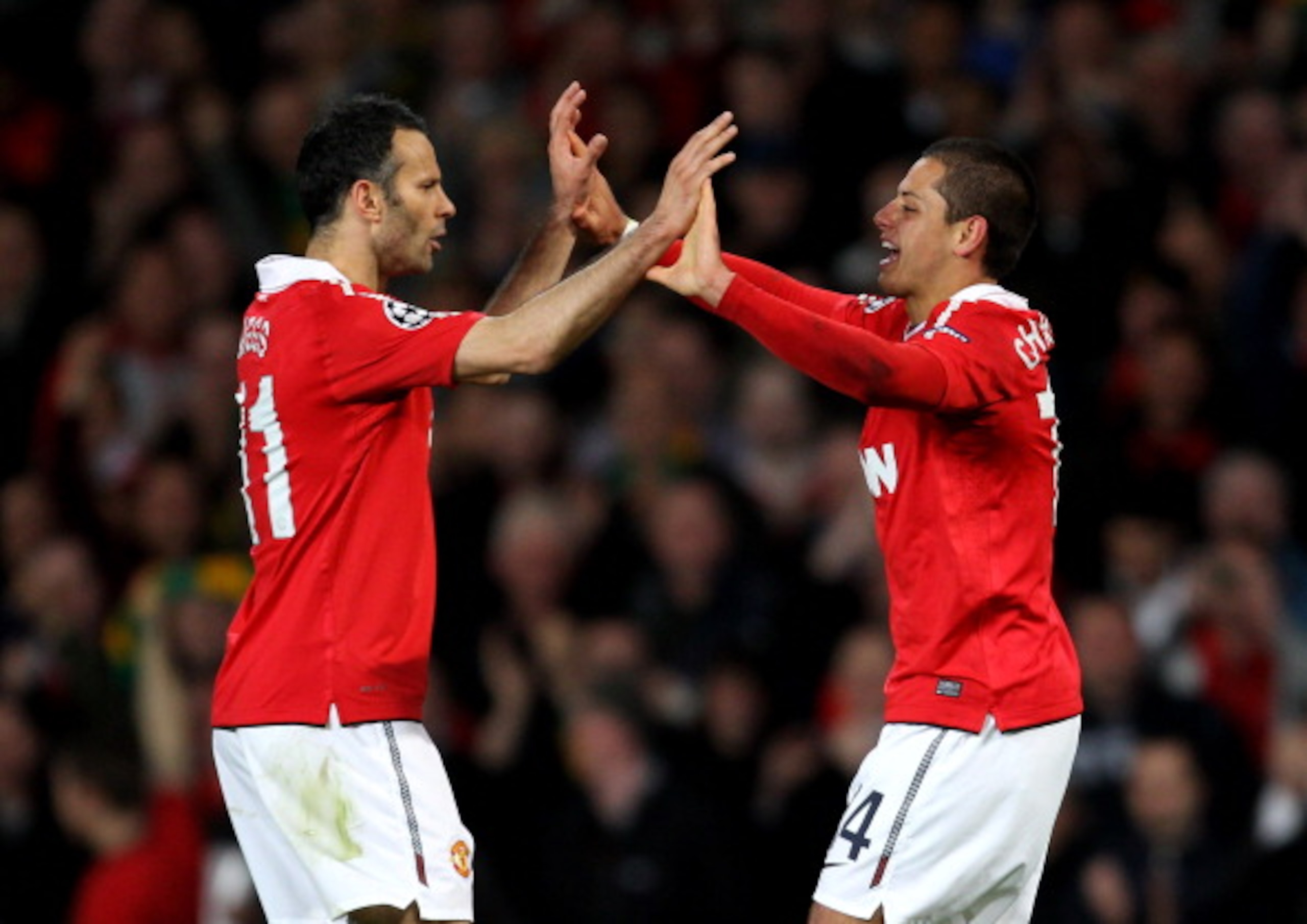 MANCHESTER, ENGLAND - APRIL 12:  Javier Hernandez of Manchester United celebrates scoring the opening goal with team mate Ryan Giggs (L) during the UEFA Champions League Quarter Final second leg match between Manchester United and Chelsea at Old Trafford