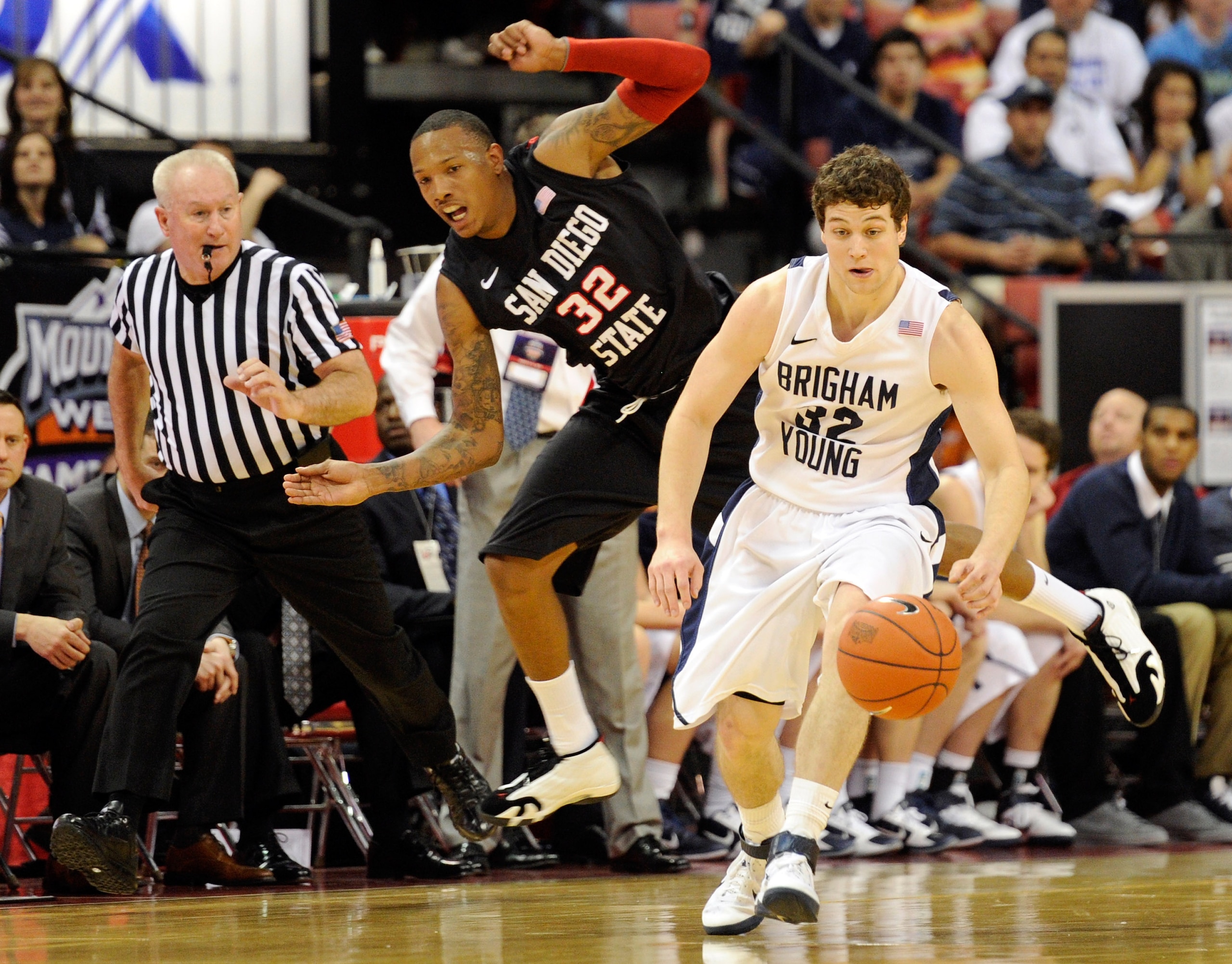 LAS VEGAS, NV - MARCH 12:  Jimmer Fredette #32 of the Brigham Young University Cougars gets away from Billy White #32 of the San Diego State Aztecs during the championship game of the Conoco Mountain West Conference Basketball tournament at the Thomas & M