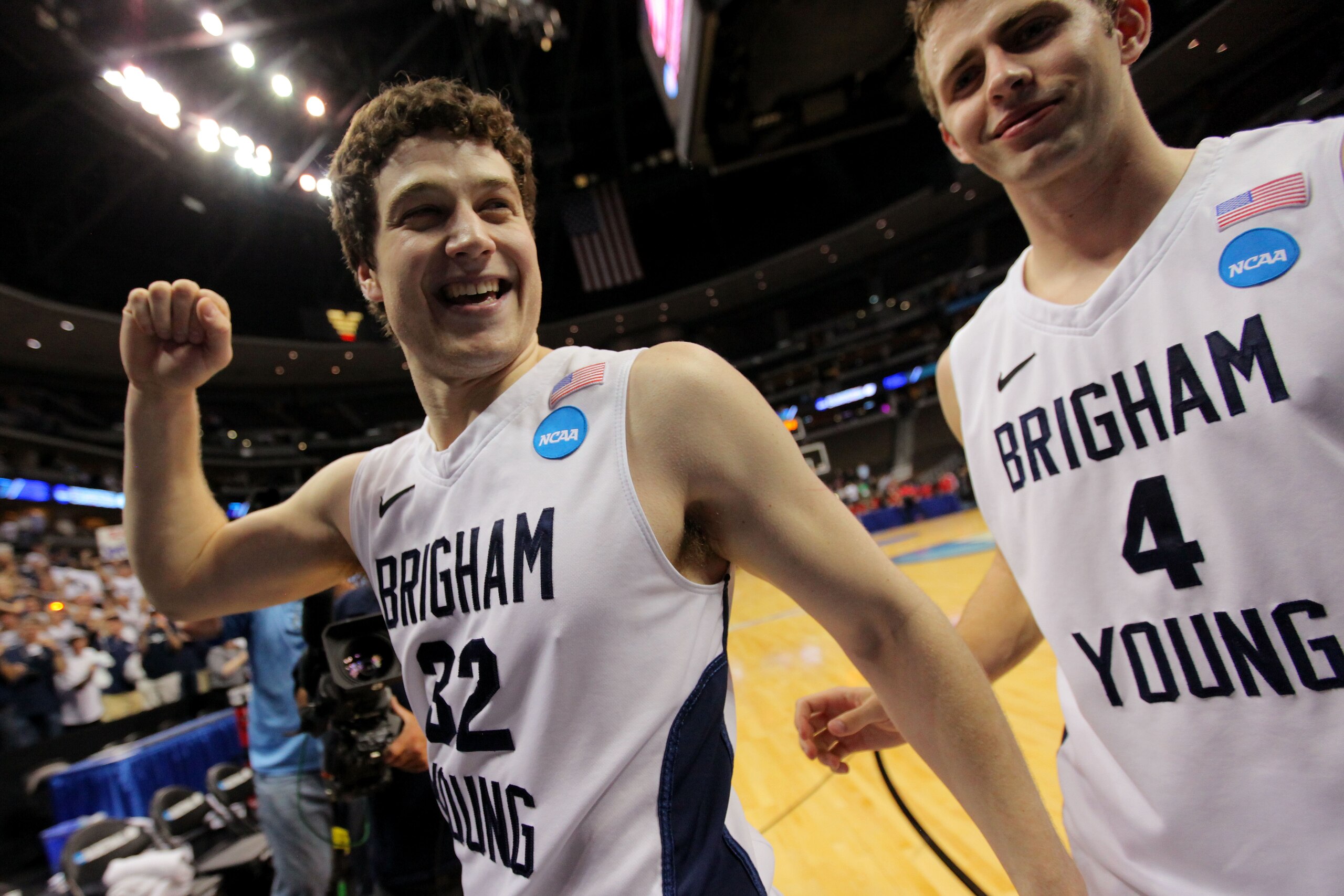 DENVER, CO - MARCH 19:  Jimmer Fredette #32 and Jackson Emery #4 of the Brigham Young Cougars walk off of the court after defeating the Gonzaga Bulldogs during the third round of the 2011 NCAA men's basketball tournament at Pepsi Center on March 19, 2011